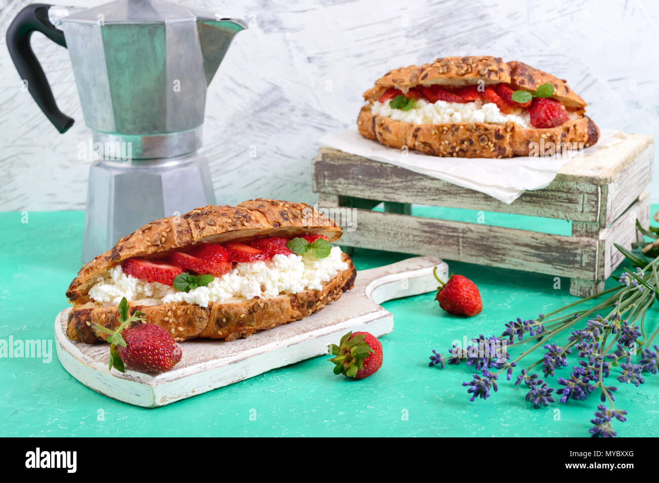 Cereal croissants with cream cheese and fresh strawberries. Useful breakfast. Proper nutrition