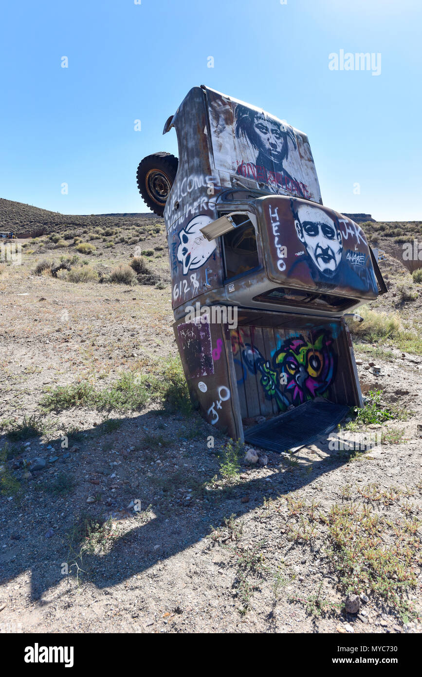 Junk car artistically buried in the desert near Goldfield Nevada Stock Photo