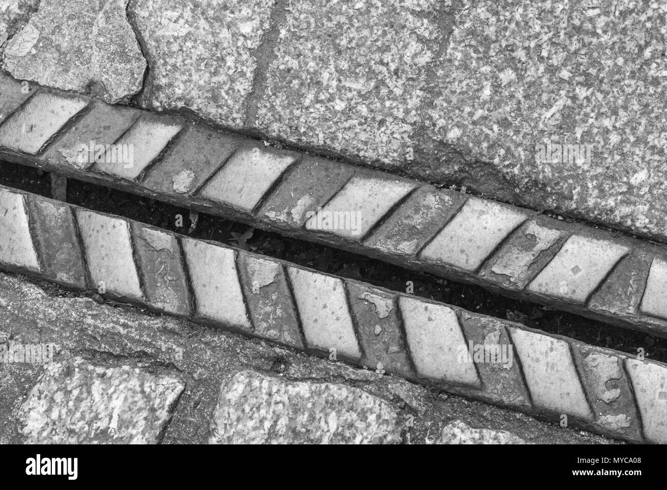 Old cast iron pavement drainage channel in Truro, Cornwall. Stock Photo