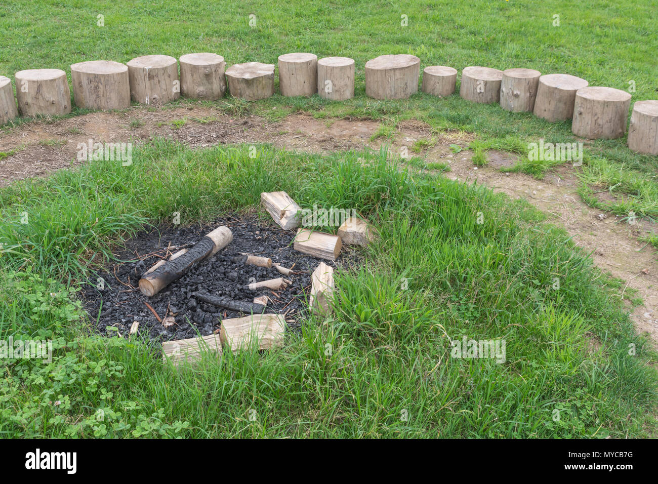 Log seating forming the 'fire circle' at an outdoors education centre. Stock Photo