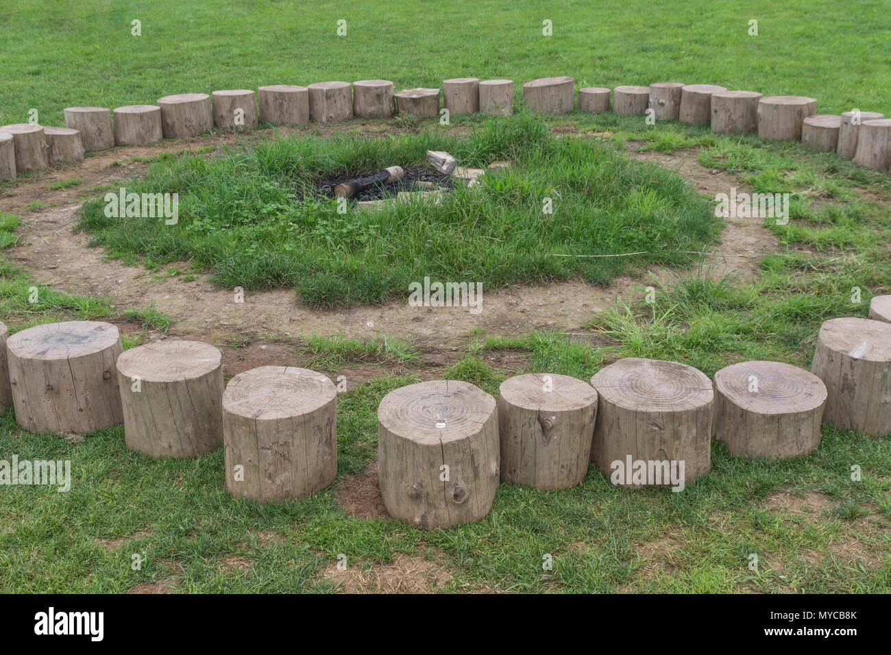 Log seating forming the 'fire circle' at an outdoors education centre. Stock Photo