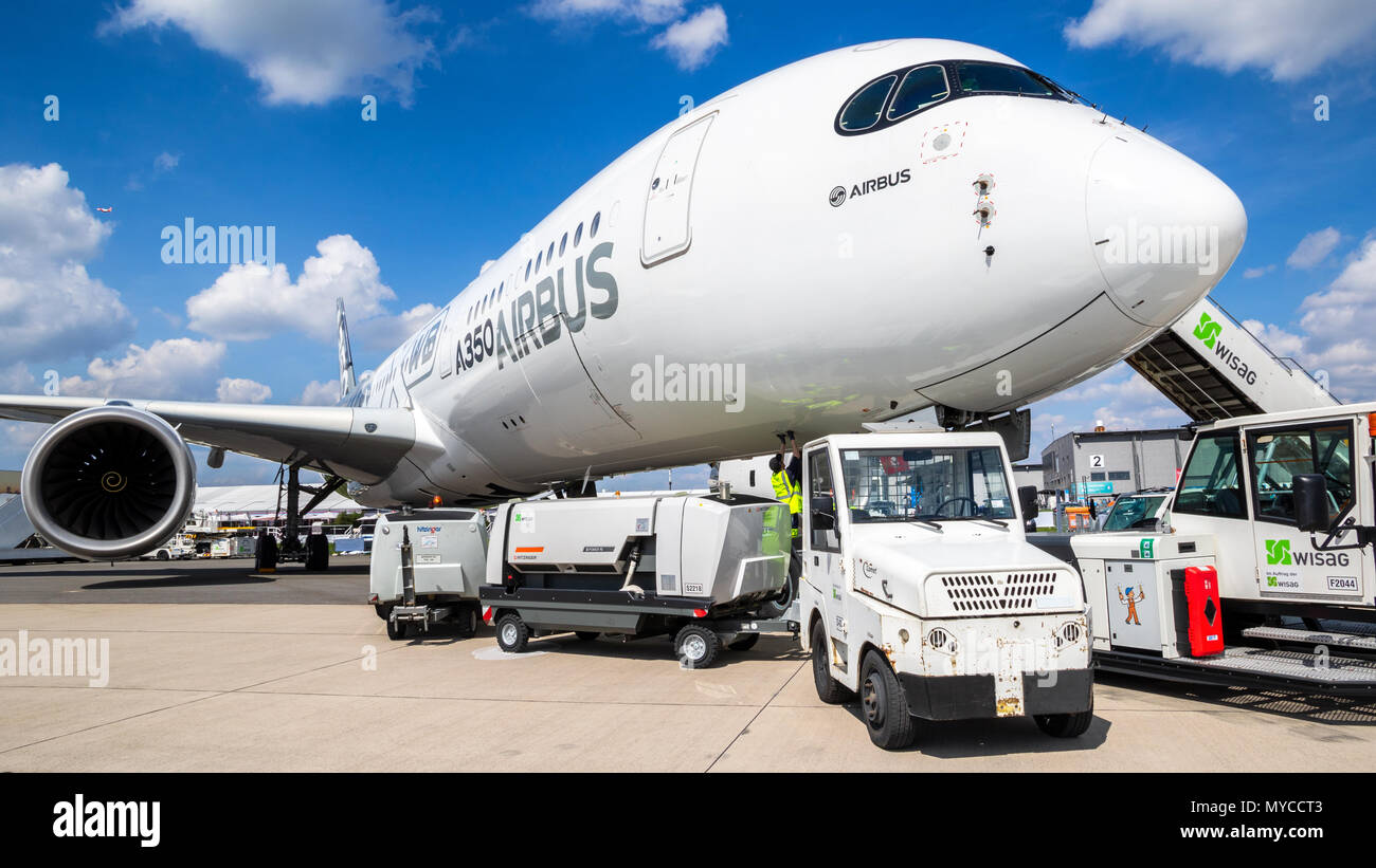 BERLIN, GERMANY - APR 27, 2018: Airbus A350 XWB passenger plane about to be towed by airport equipment at the Berlin ILA Air Show. Stock Photo