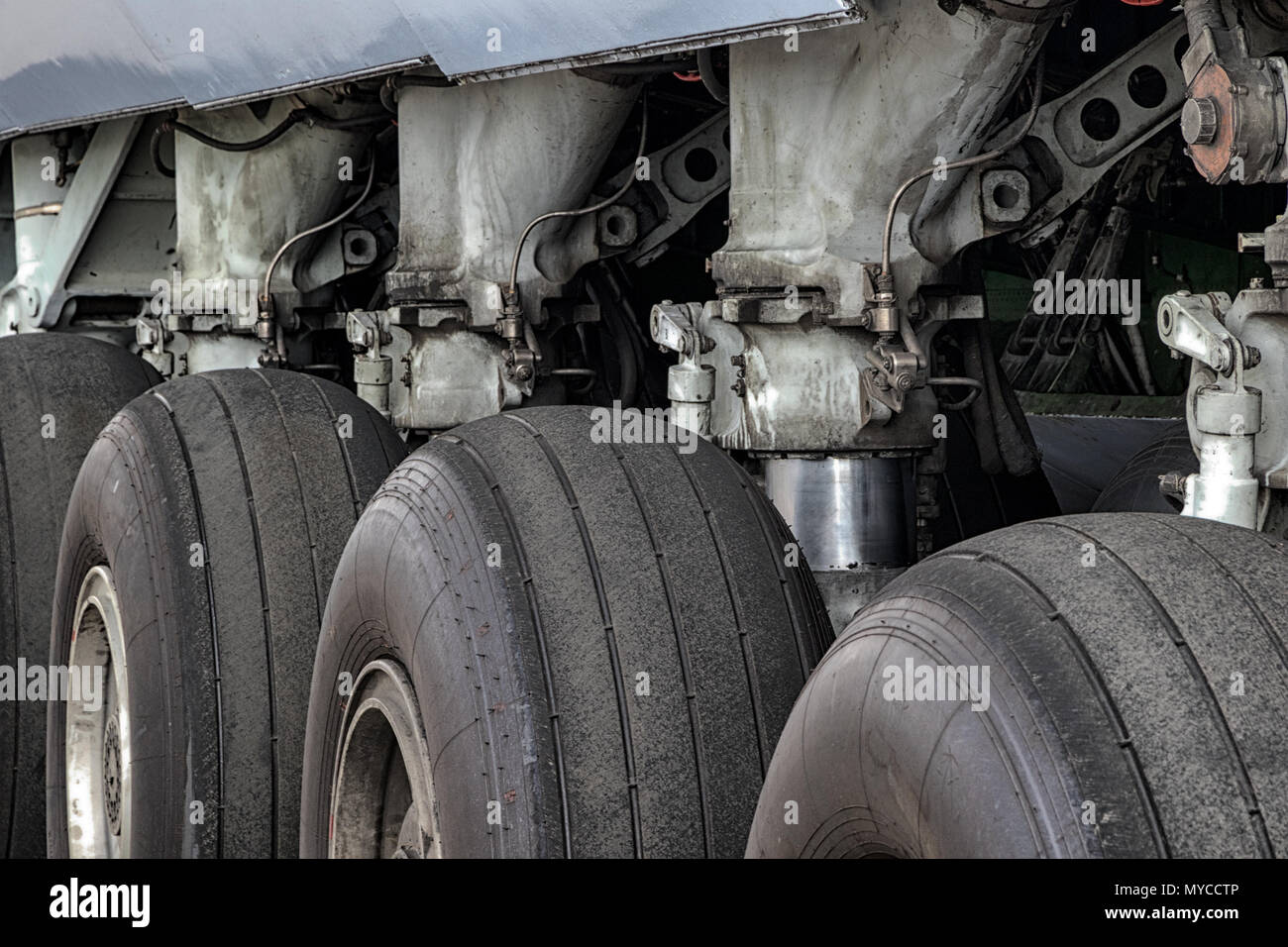 Close up view of a row of tires on the main landing gear of a large transport plane. Stock Photo