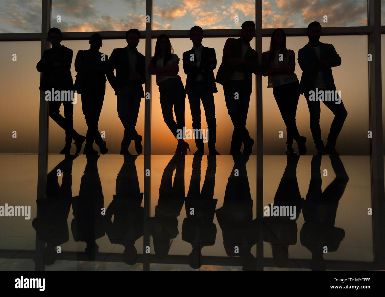 silhouette of a business team standing next to the office window Stock ...
