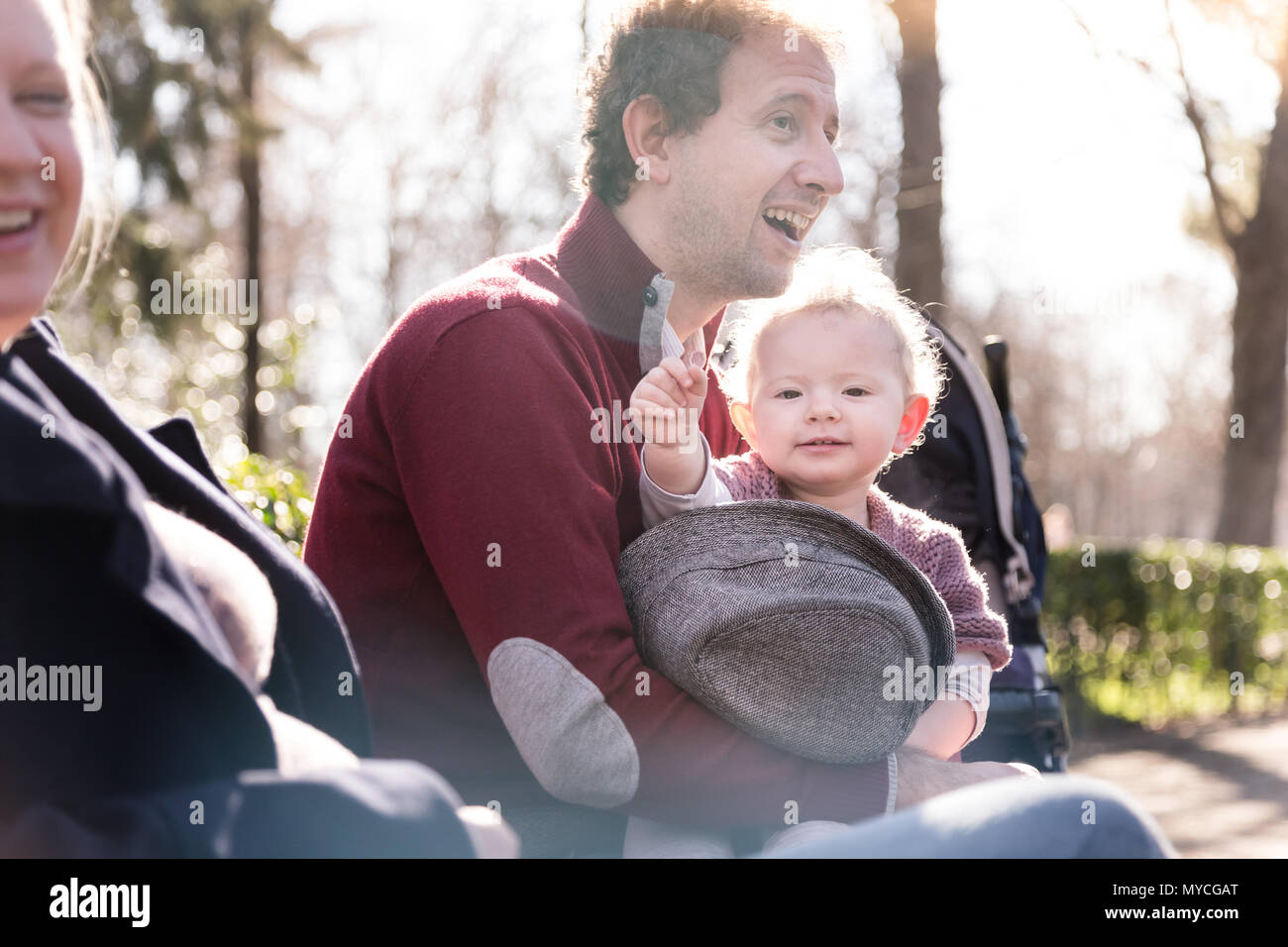 Young family with cheerful child in the park. Stock Photo