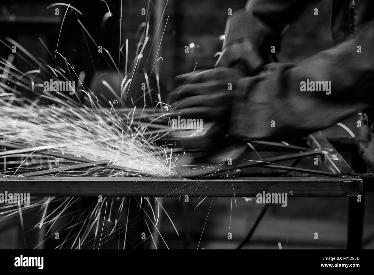 A grinder smoothing a metal table Stock Photo