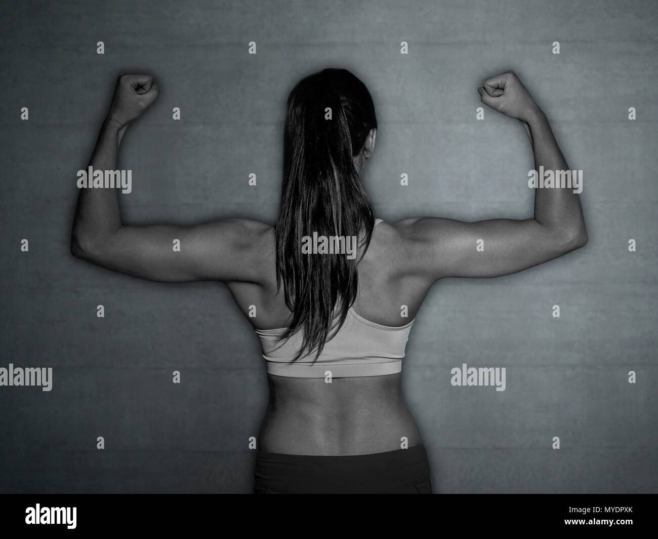 Rear view muscular woman flexing hi-res stock photography and images - Alamy