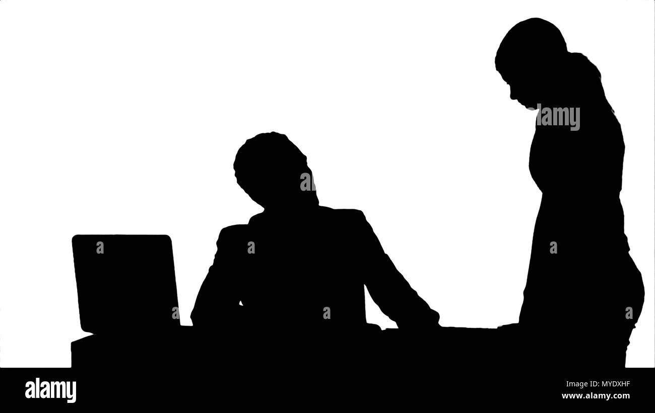 Silhouette Angry boss with female worker in office Stock Photo