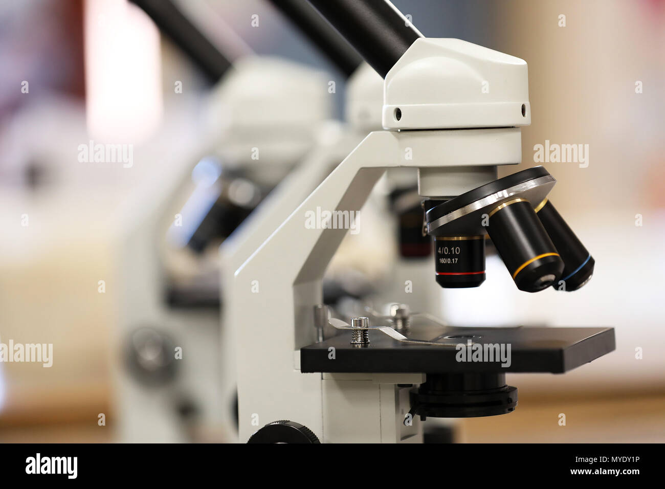 close up of a pair of electronic microscopes in a science classroom or laboratory research facility. knowledge, medicine, pathology, medical concept. Stock Photo