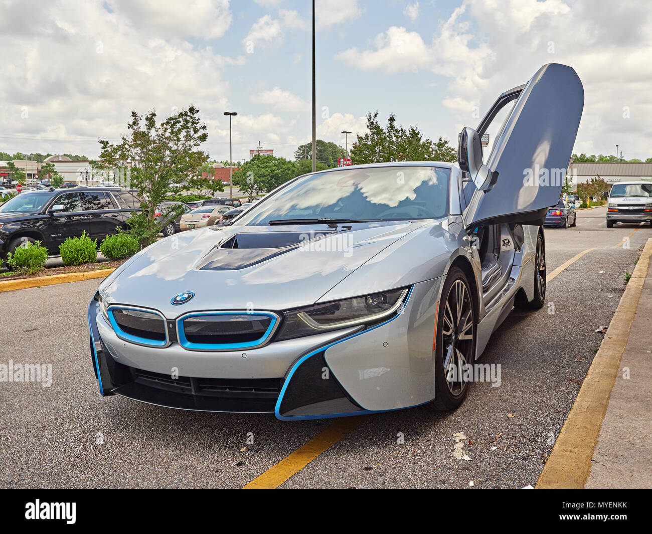 BMW i8 plug in hybrid super car or sports car parked at the curb with driver's door open showing the cockpit of the hybrid electric automobile in USA. Stock Photo