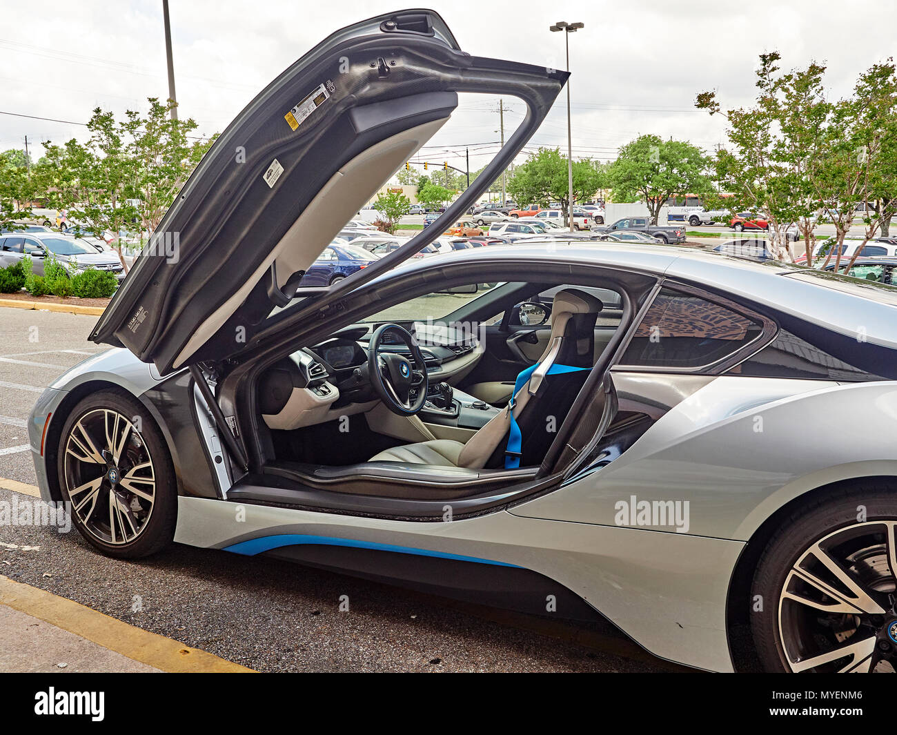 BMW i8 plug in hybrid super car or sports car parked at the curb with driver's door open showing the cockpit of the hybrid electric automobile in USA. Stock Photo