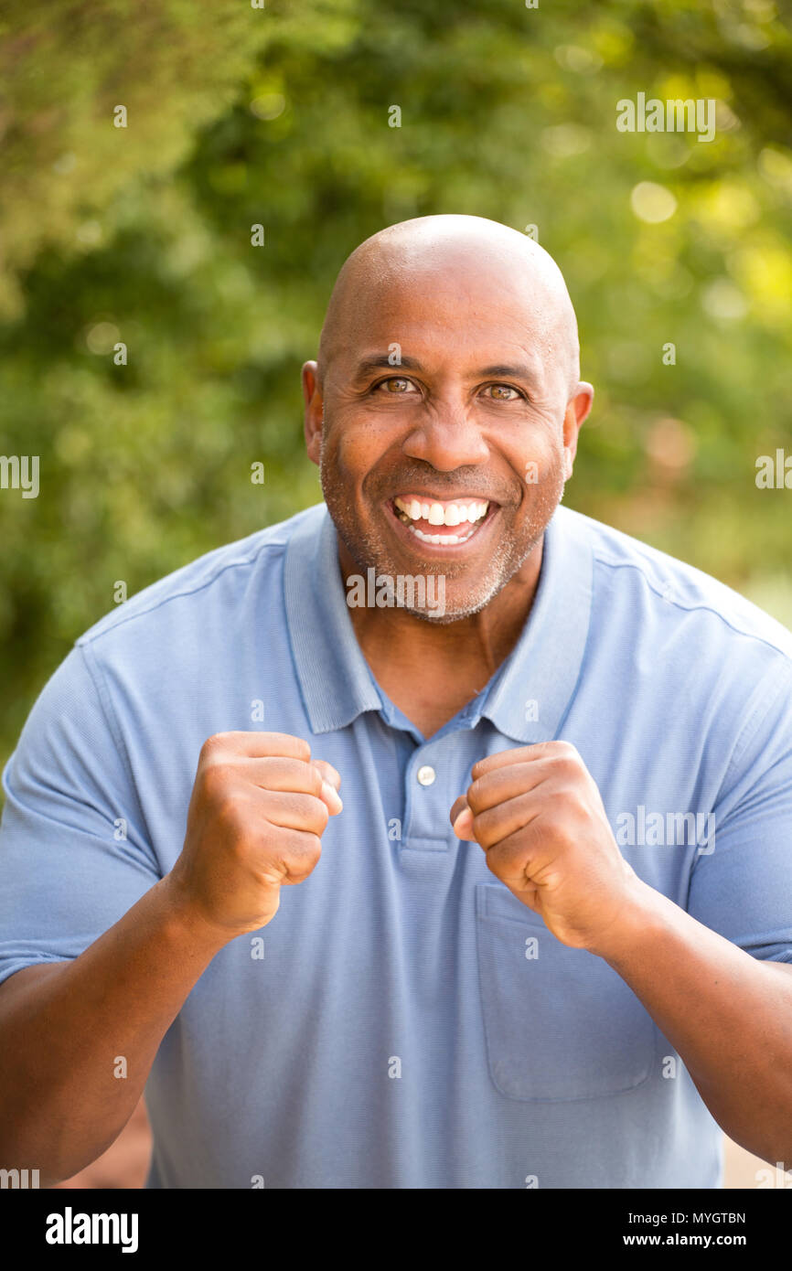 Excited African American man pumping his fist Stock Photo - Alamy