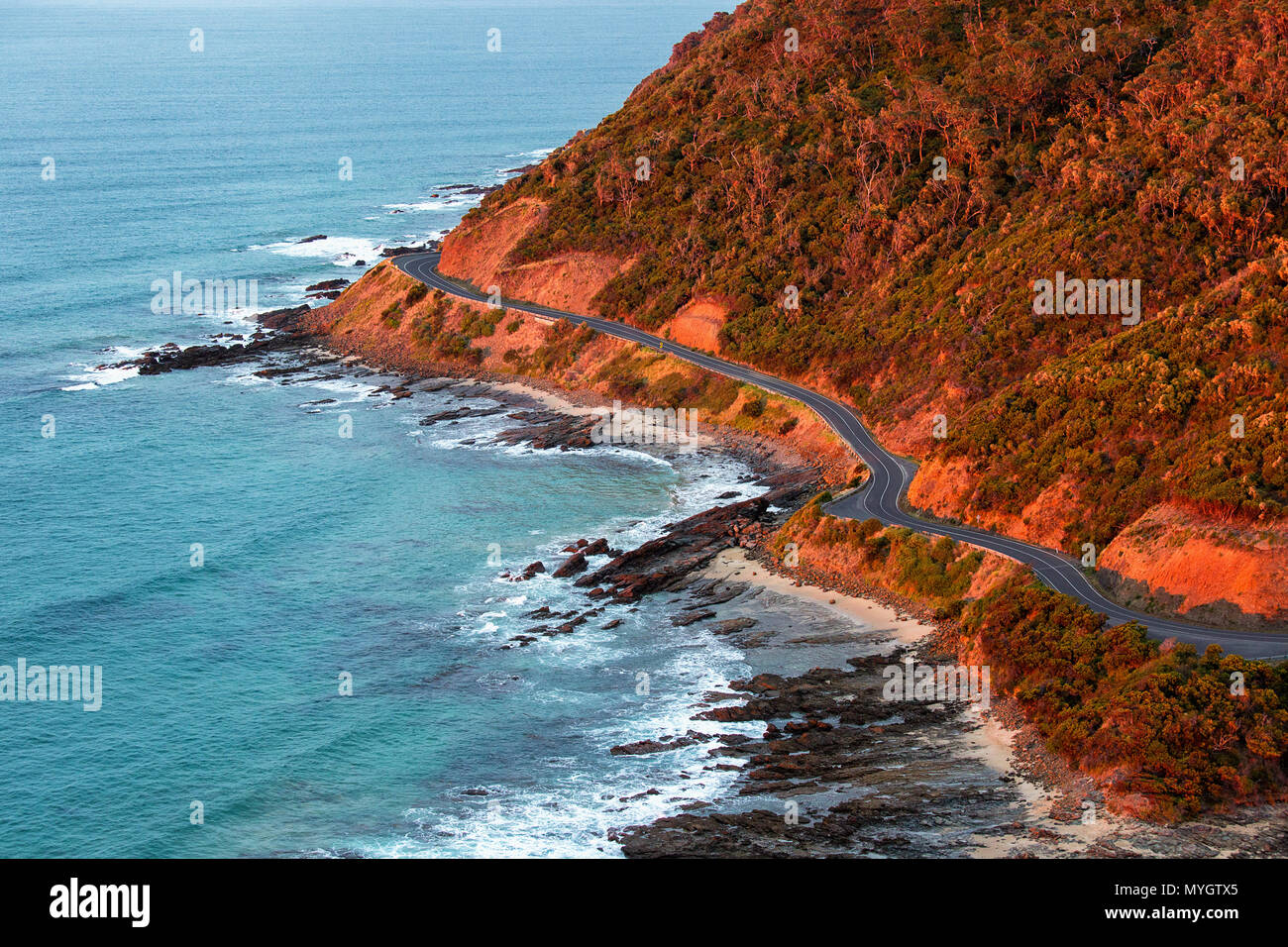 Curved Great Ocean Road along the coastline at sunrise, Victoria, Australia Stock Photo