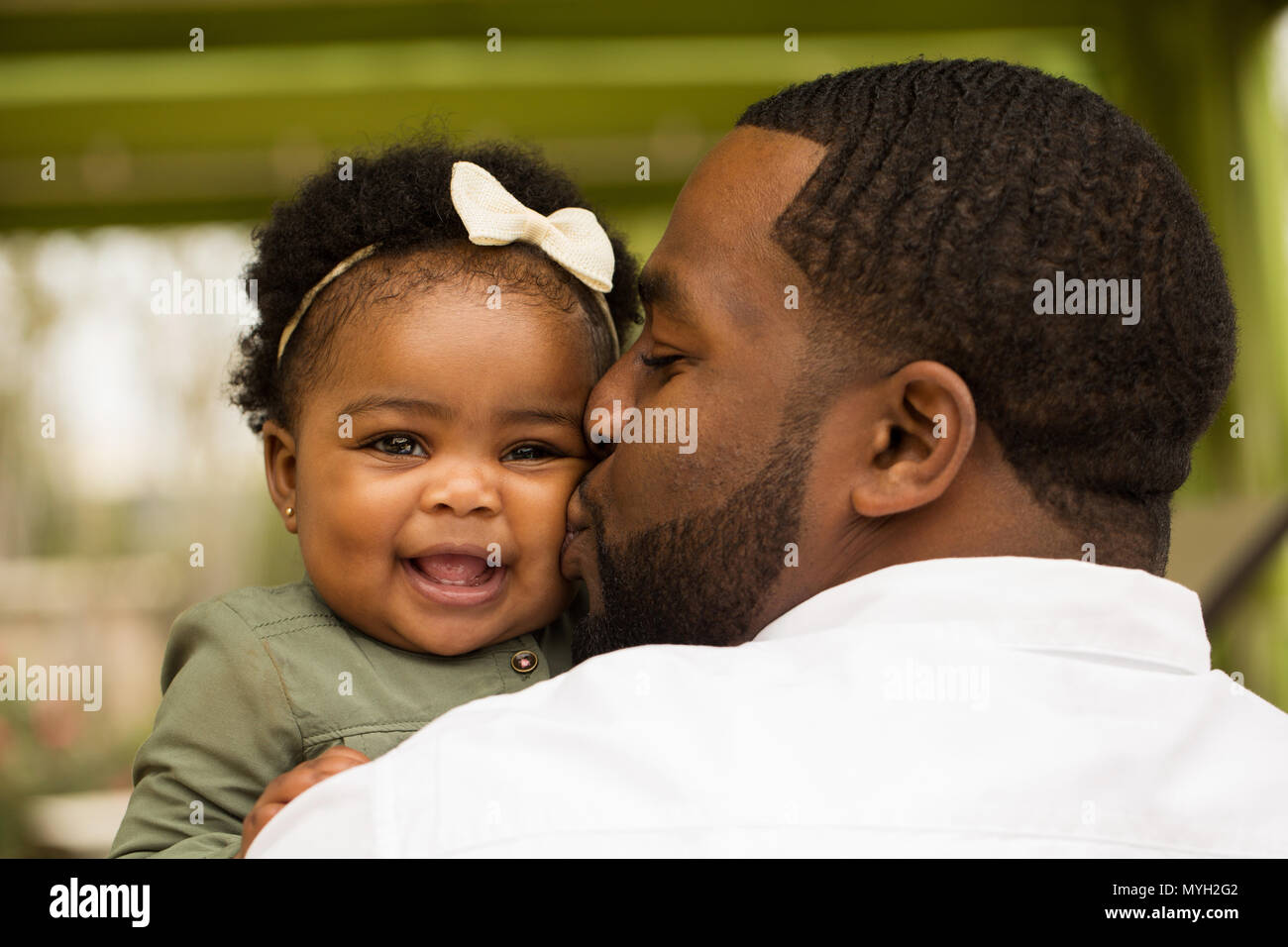African American loving father holding his daughter Stock Photo - Alamy