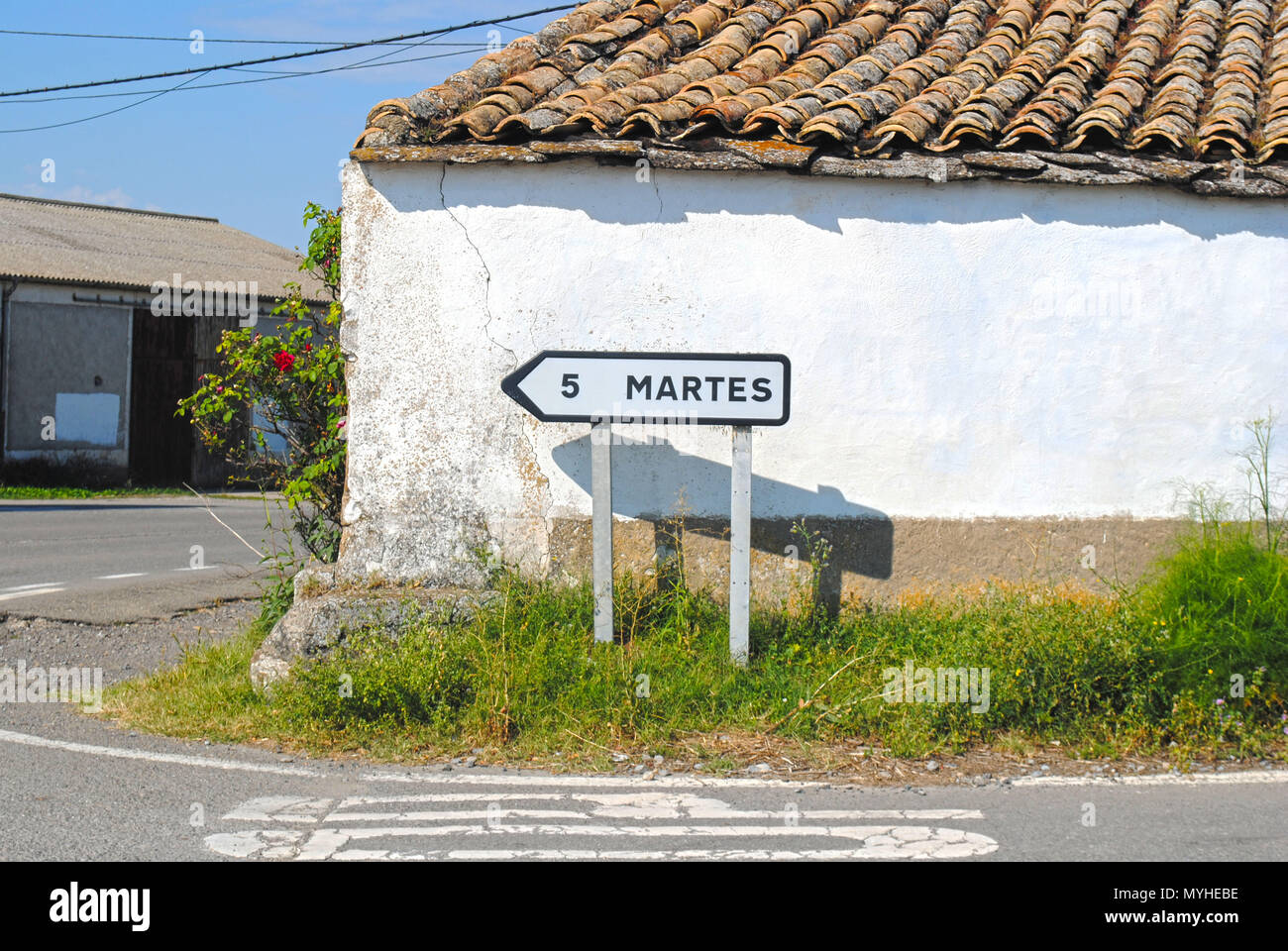 A black and white road sign pointing to the left, towards the village of  Martes in the foothills of the Pyrenees in Spain Stock Photo - Alamy