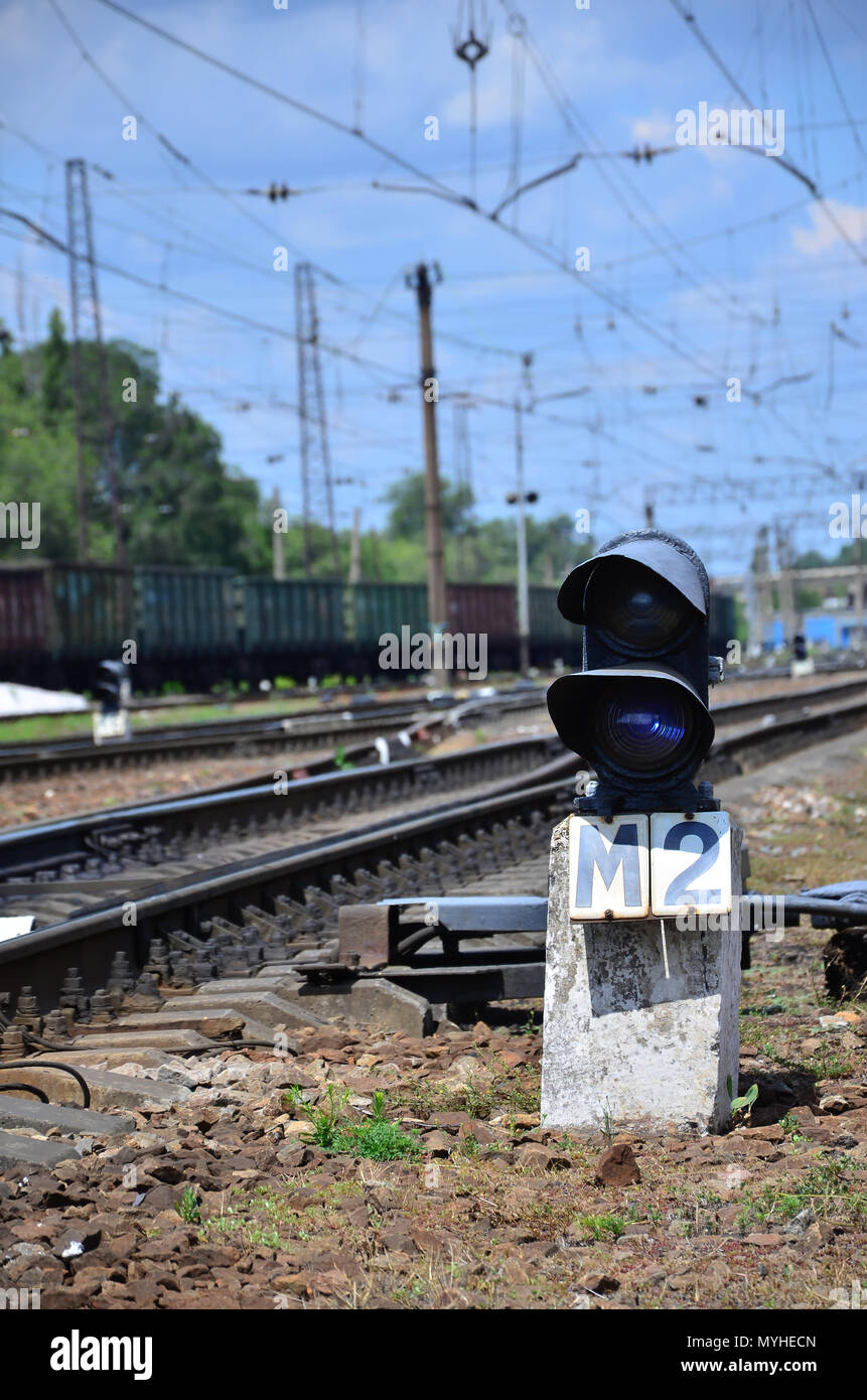 Railway traffic light (semaphore) against the background of a day railway landscape. Signal device on the railway track Stock Photo