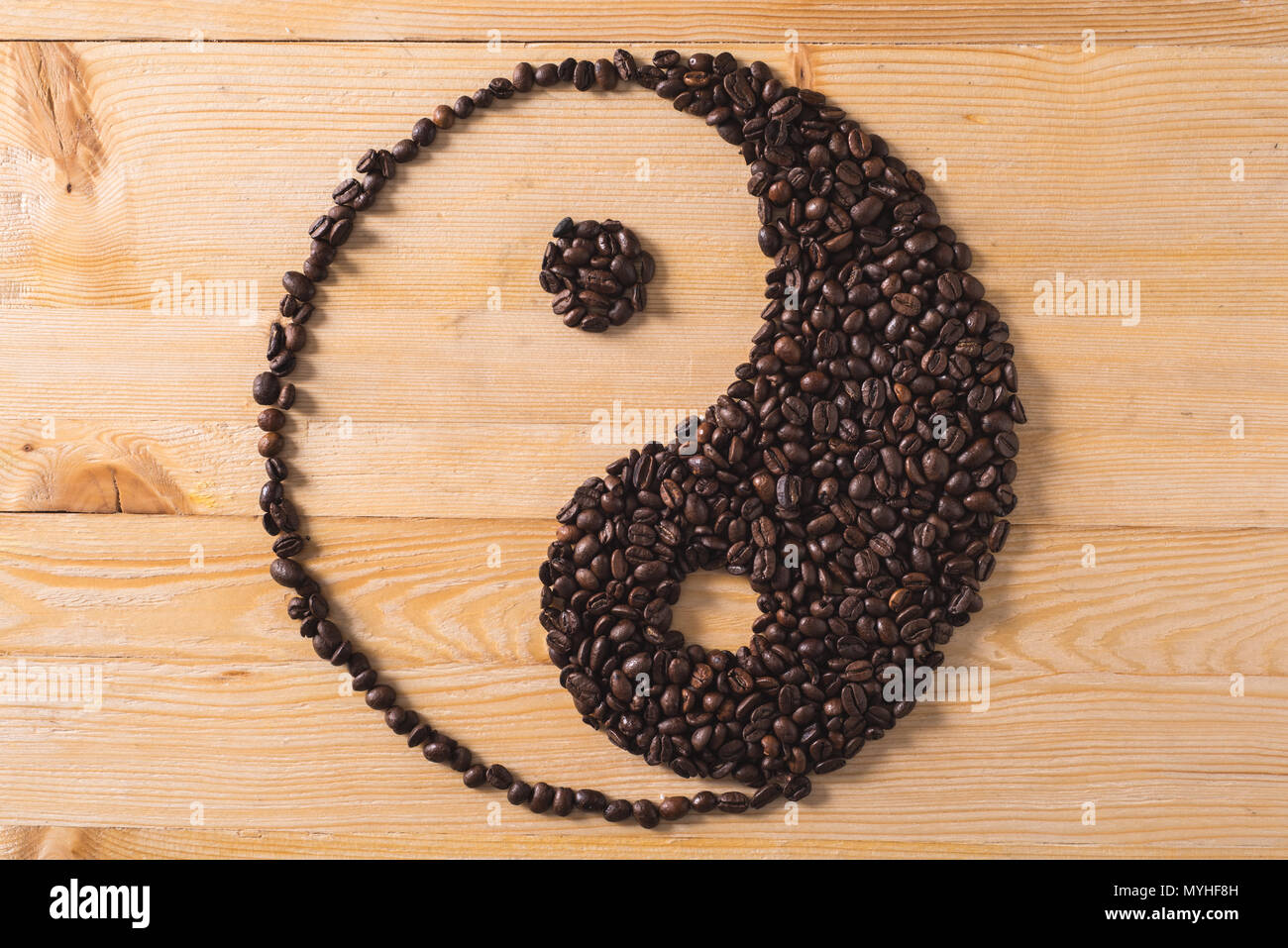 ying yang coffee composition on wood table with warm light Stock Photo