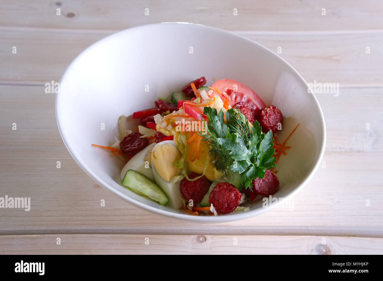 Salad with homemade sausage, egg, tomato, cucumber and mustard Stock Photo