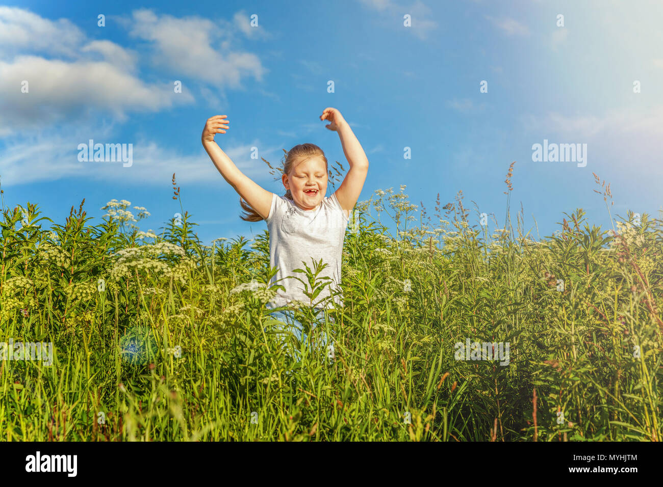Happy cute little girl running on the grass in the park. Happiness ...