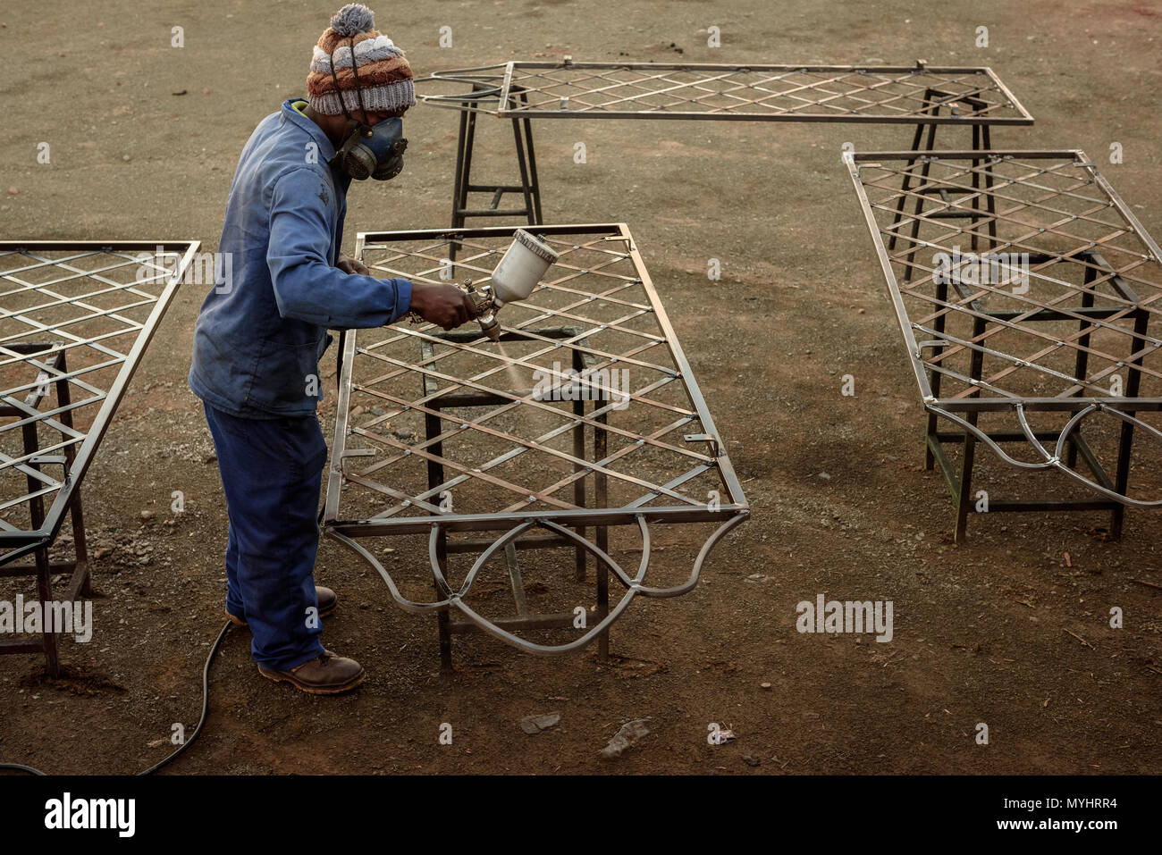 Metal Work Rural A metal worker in South Africa's Eastern Cape sealing a metal table at ...