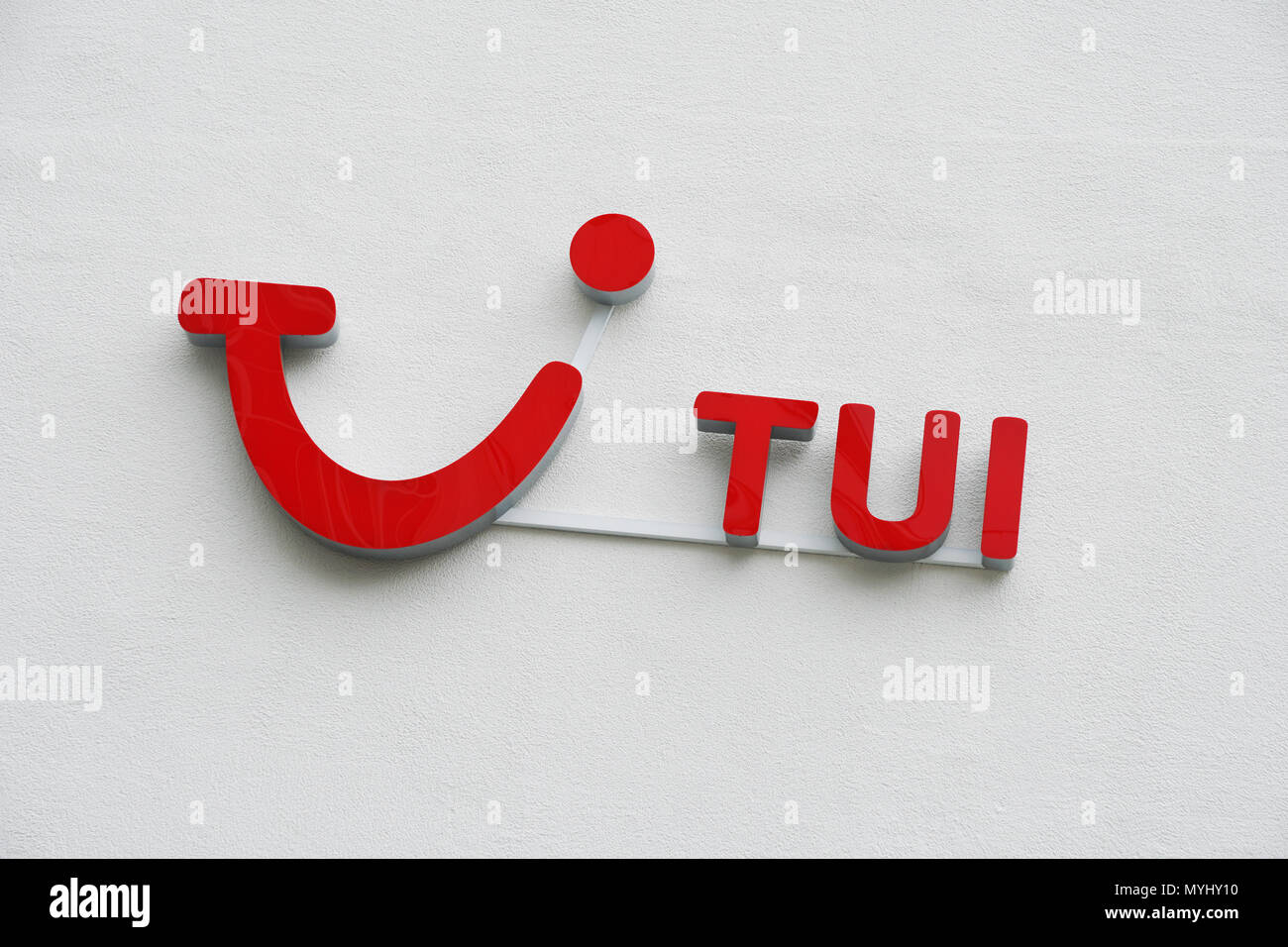 Hannover, Germany - June 6, 2018: TUI logo and brand sign on wall. TUI Group is the largest travel and tourism company in the world, headquartered in Hannover. Stock Photo