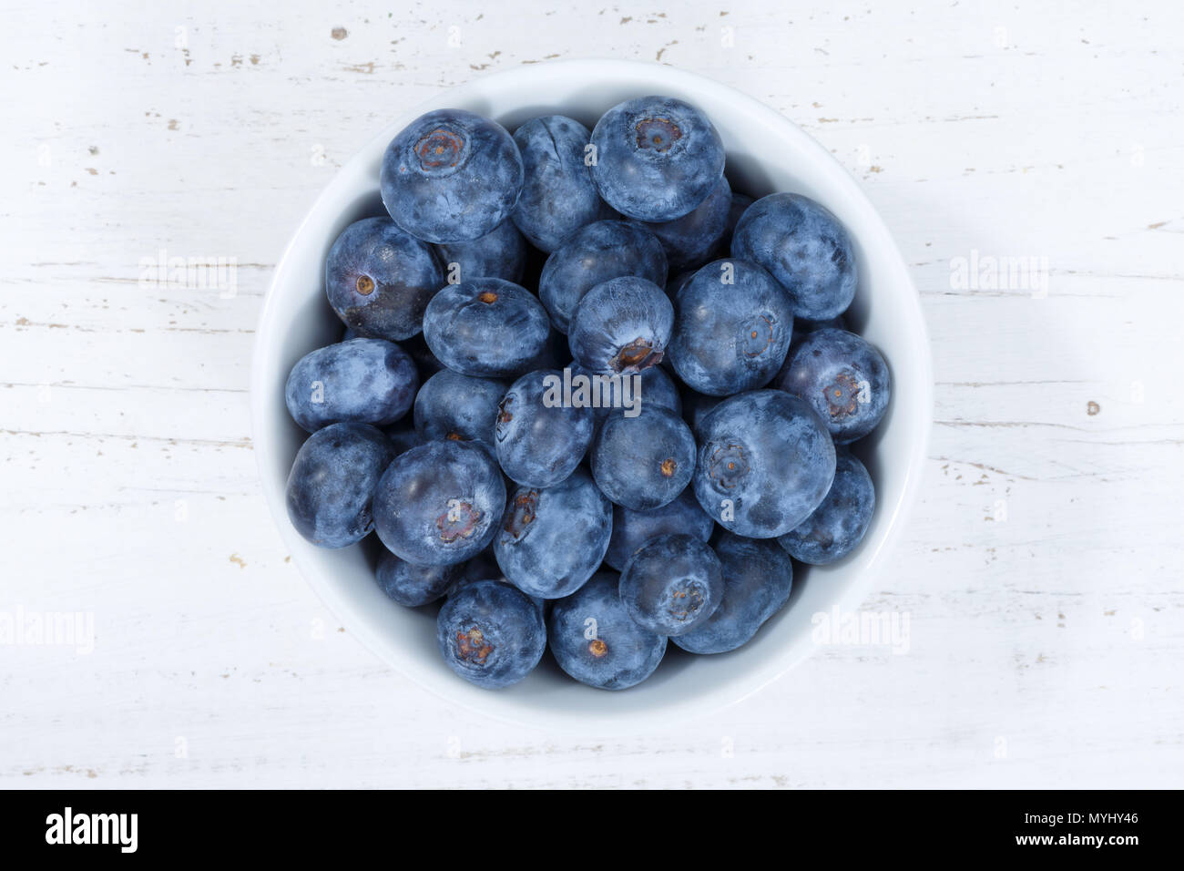 Blueberries berries from above bowl wooden board wood Stock Photo