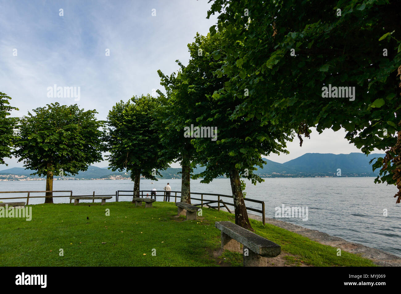 Cannobbio, Italy, June 10, 2016 - Lakeside Park with two people near the water, Lago Maggiore, Beach of Cannero Riviera Stock Photo