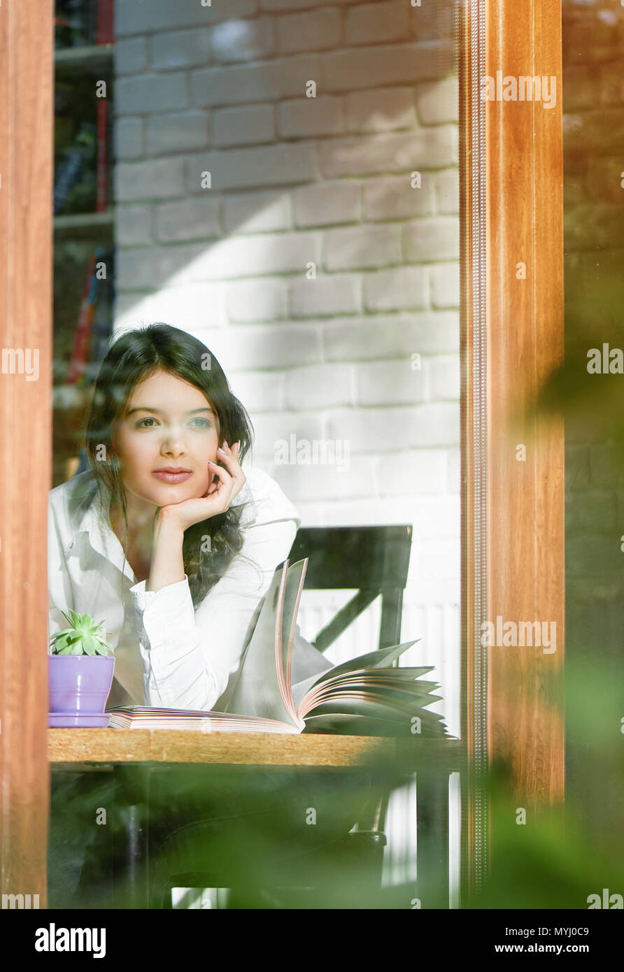 Young Girl Looking Outside Throw Window Glass Having Short Black