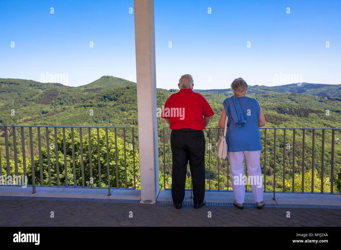 Germany, Siebengebirge, visitors on the terrace of the Drachenfels mountain looking to the arboreous hills of the natural park Siebengebirge near Koen Stock Photo