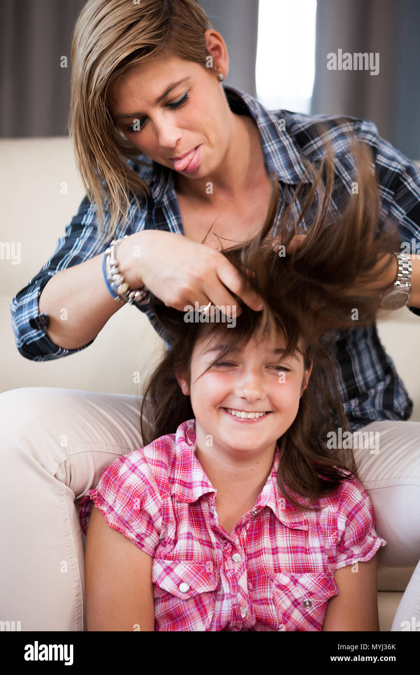 Close up portrait of mother combing her daughter hair Stock Photo Alamy