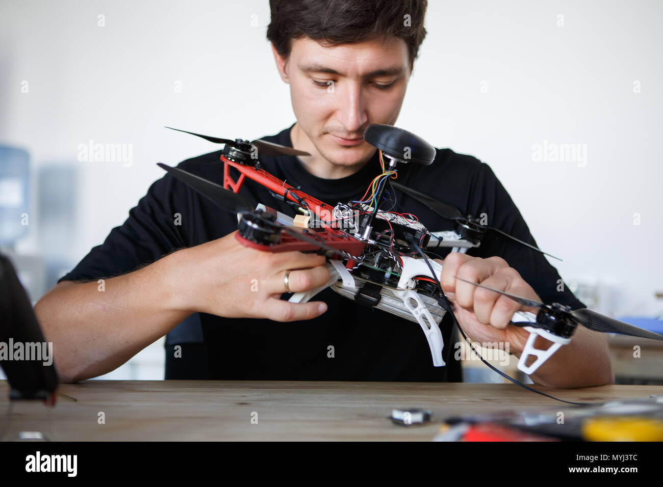 Image of engineer mending square copter at table Stock Photo