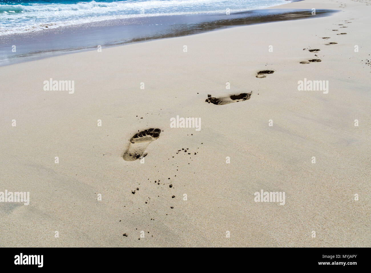 Mallorca, Footmark in sand beach while sun shines Stock Photo