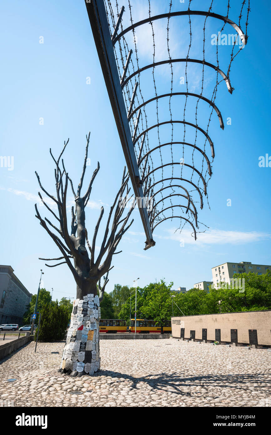 Warsaw Pawiak, view of a section of original barbed wire gateway and memorial tree at the entrance to the Pawiak Prison Museum in Warsaw, Poland. Stock Photo