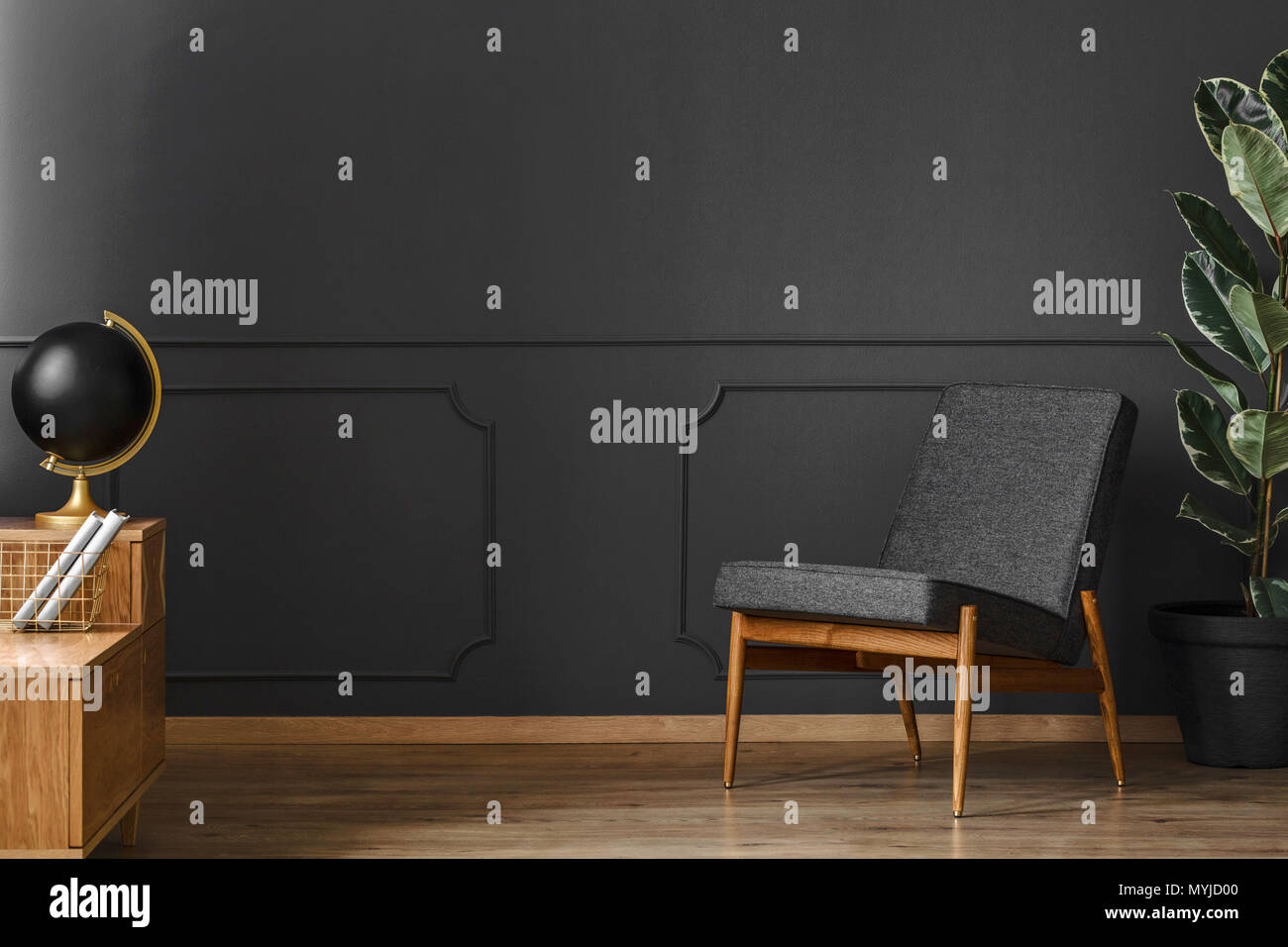 Spacious, black retro room interior with black walls, chair, wooden ...