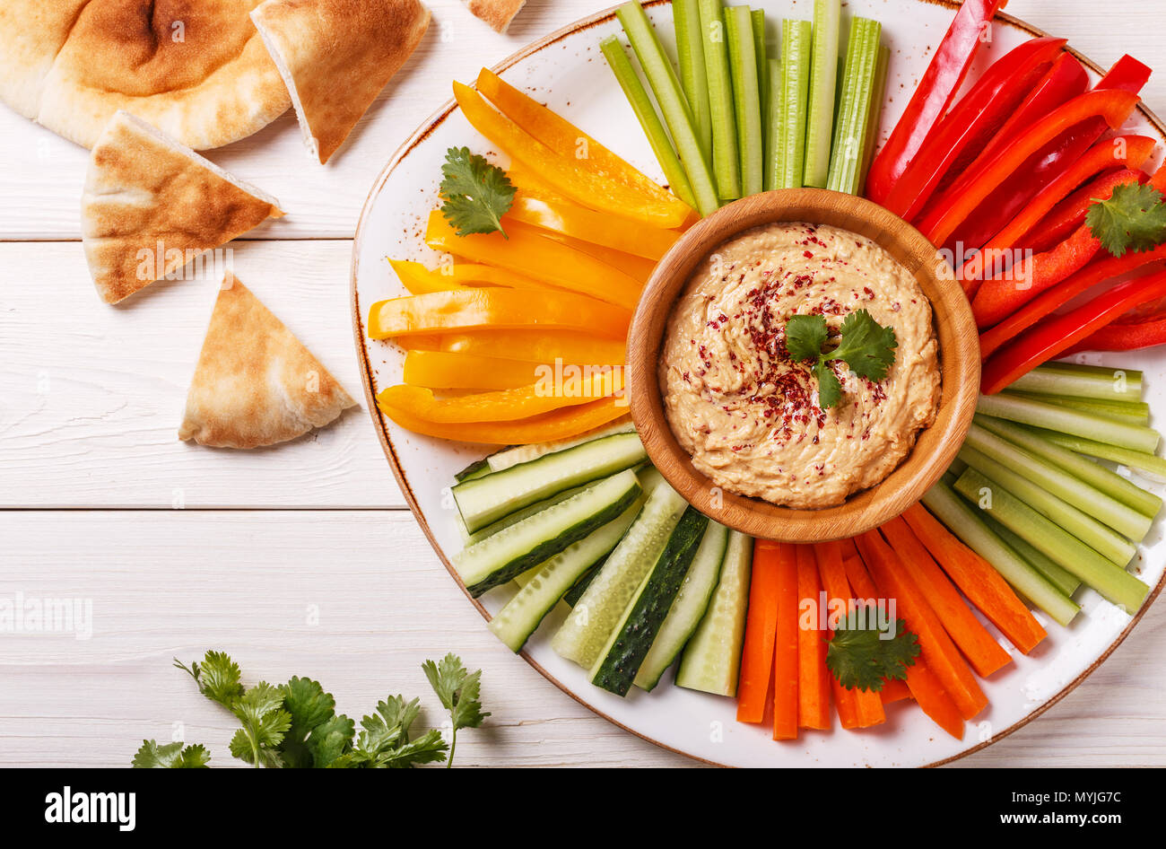 Healthy homemade hummus with assorted fresh vegetables and pita bread ...