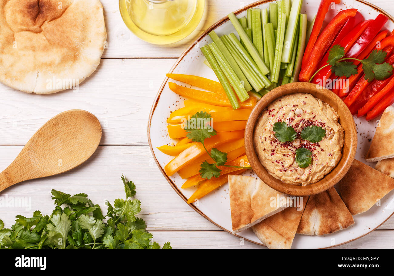 Healthy homemade hummus with assorted fresh vegetables and pita bread ...