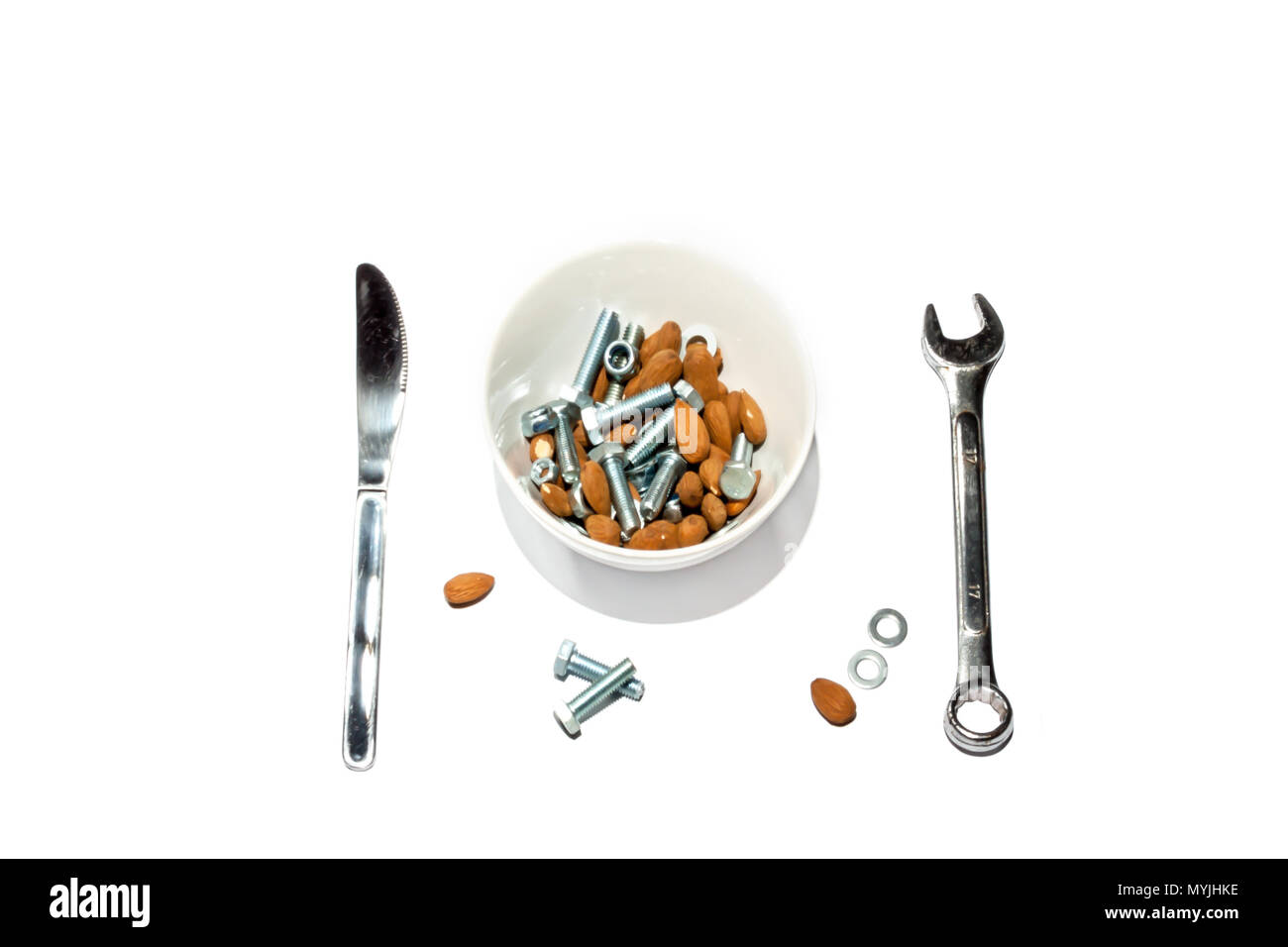 Cereal bowl filled with hard to digest almonds, nuts and bolts with a