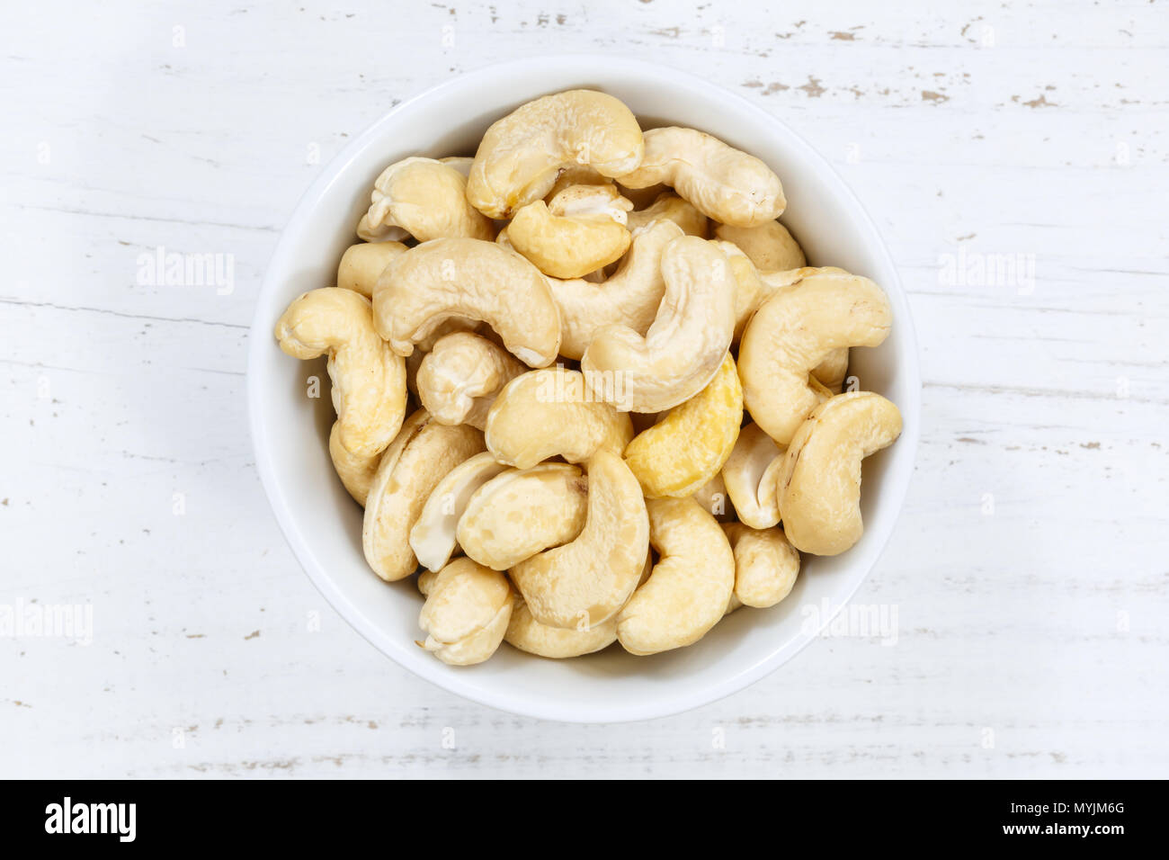 Cashew nuts cashews from above bowl wooden board wood Stock Photo