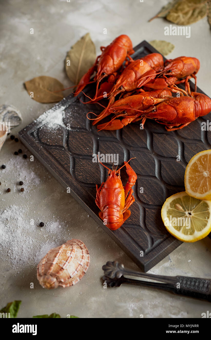 Boiled crawfish on a wooden Board, a lemon and Bay leaf. Healthy, tasty