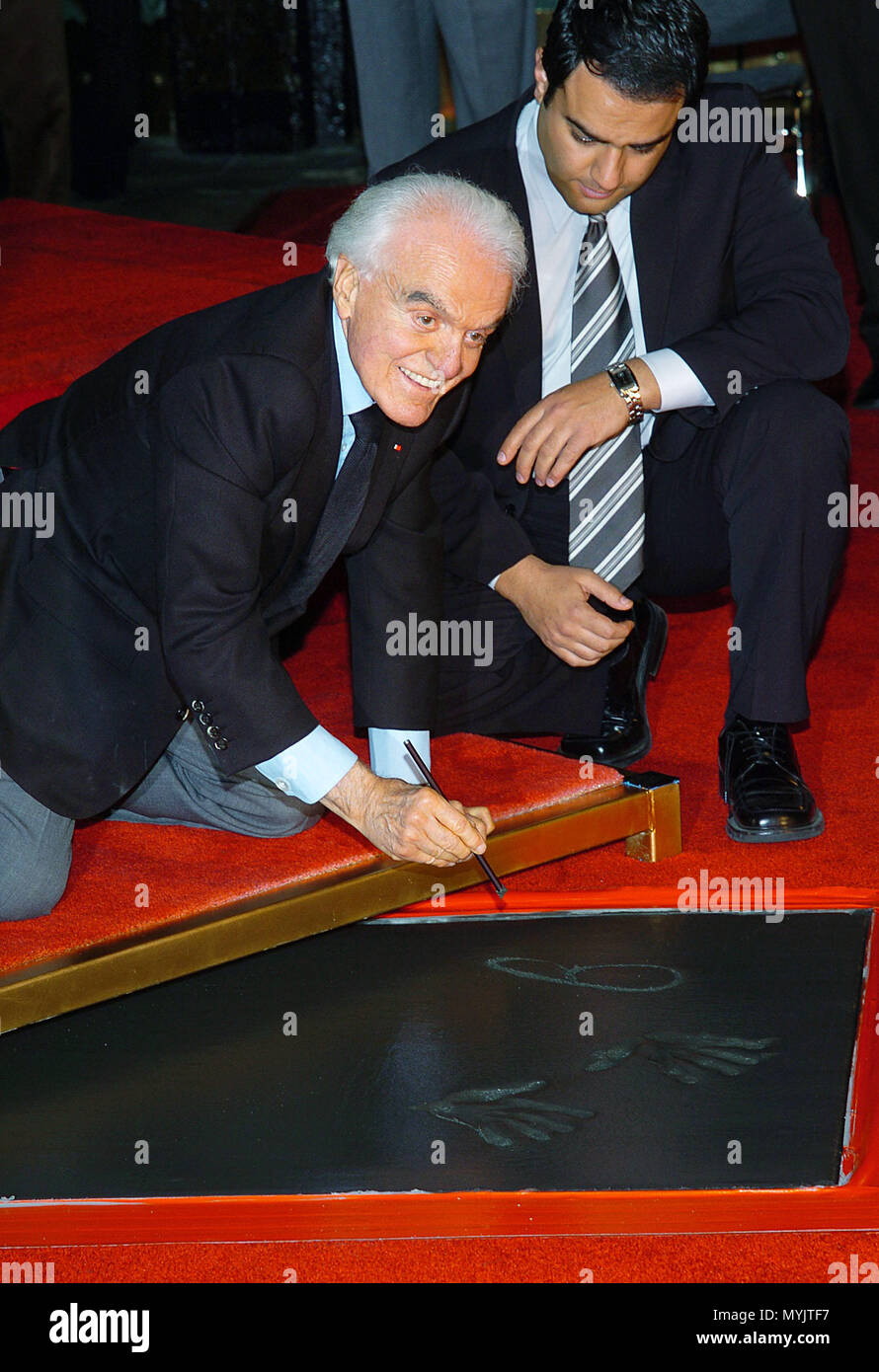 Red Buttons and wife Alicia at a hand and footprint ceremony for Jack  Valenti at Grauman's Chinese Theatre, Los Angeles, CA, Decmeber 6, 2004.  (photo: Michael Germana/Everett Collection Stock Photo - Alamy