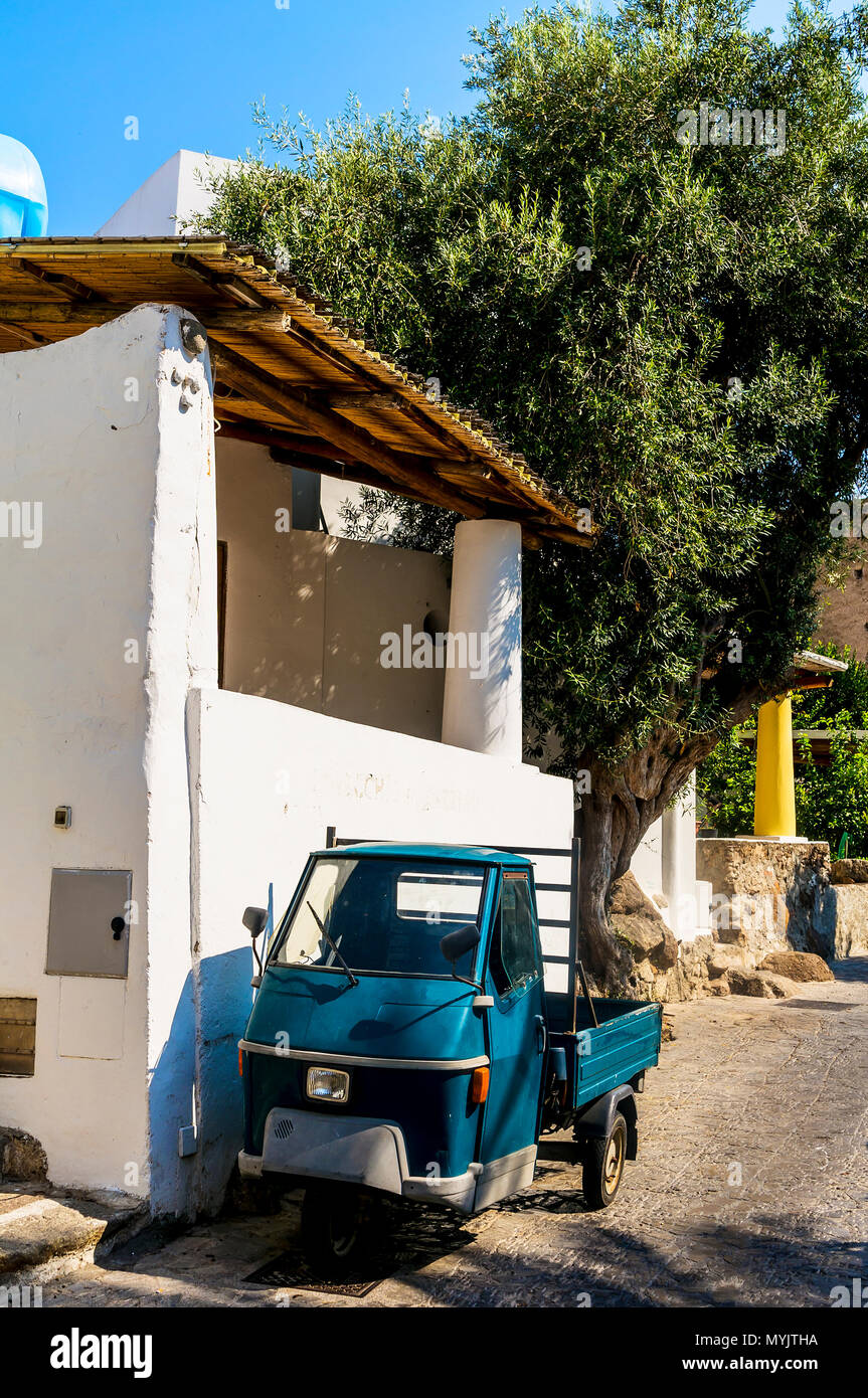 Tiny truck / car in Italy parked on the side of a road. Frontal view Stock Photo