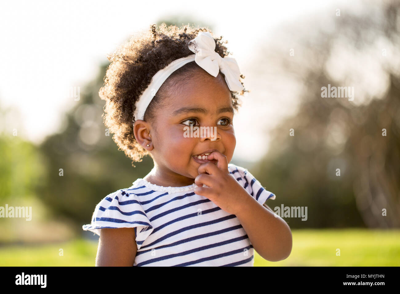 Happy African American little girl laughing and smiling outside Stock ...