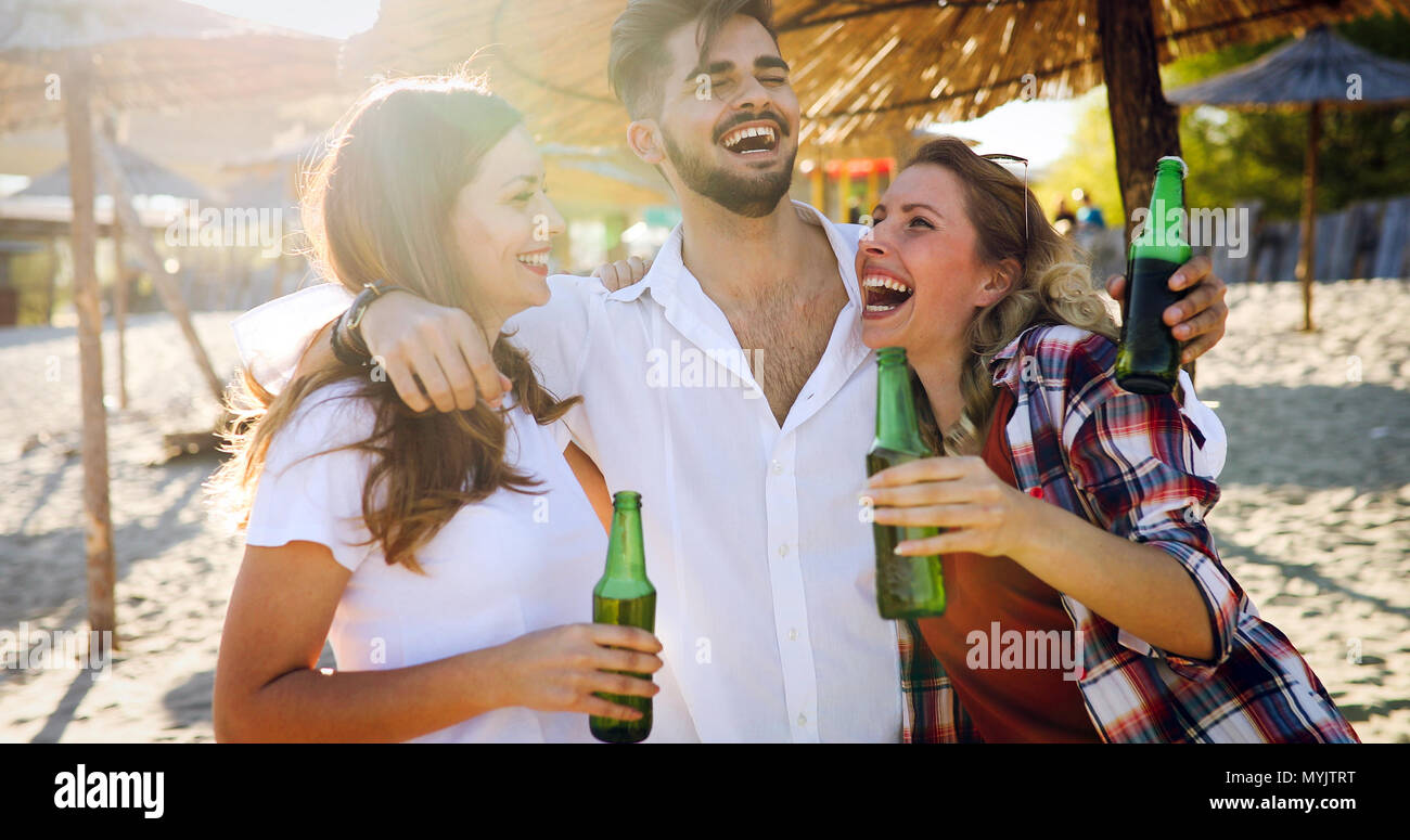 Beach party with friends. Cheerful young people spending nice time together on the beach Stock Photo