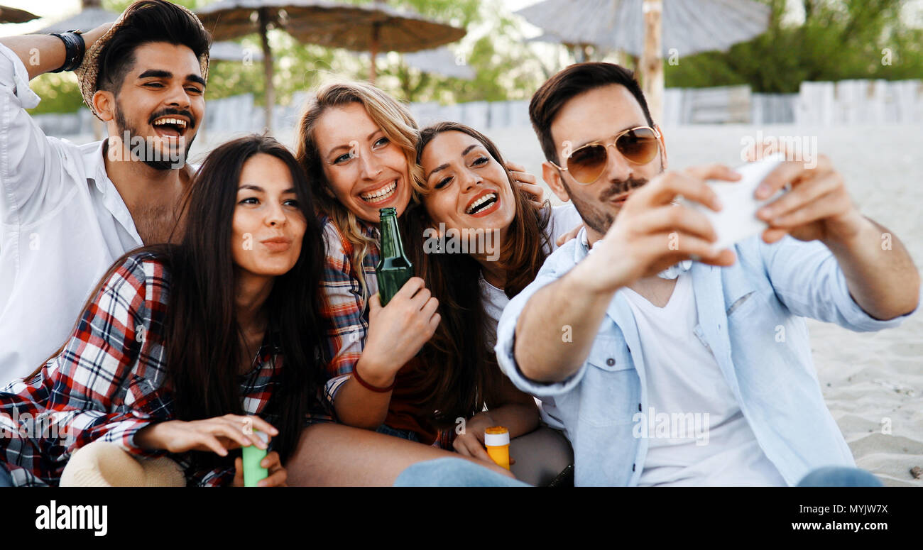 Happy young people taking selfies Stock Photo - Alamy