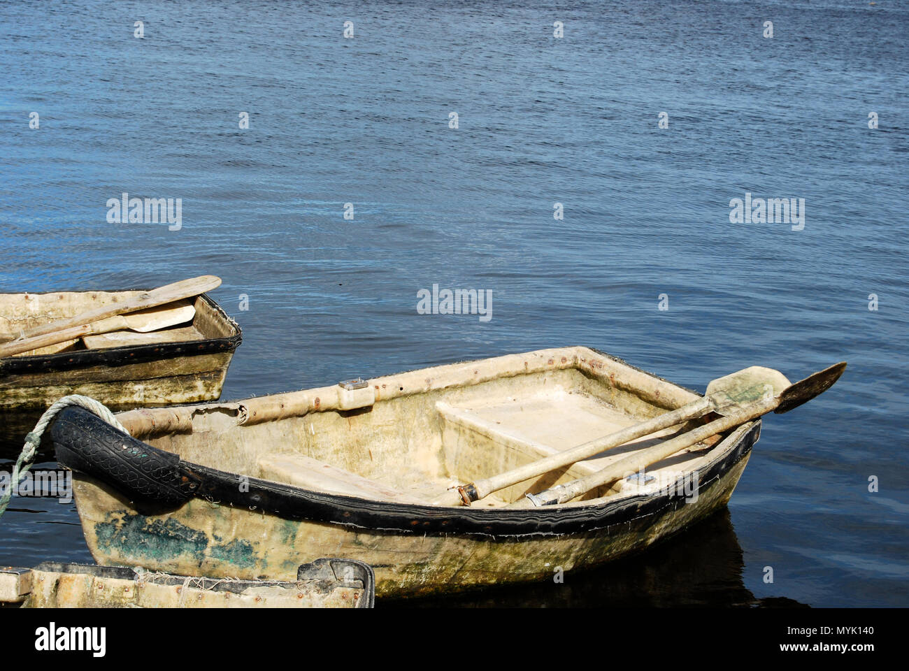 A simple rowboat with oars tied up in the harbour, Kinvara Ireland Stock Photo