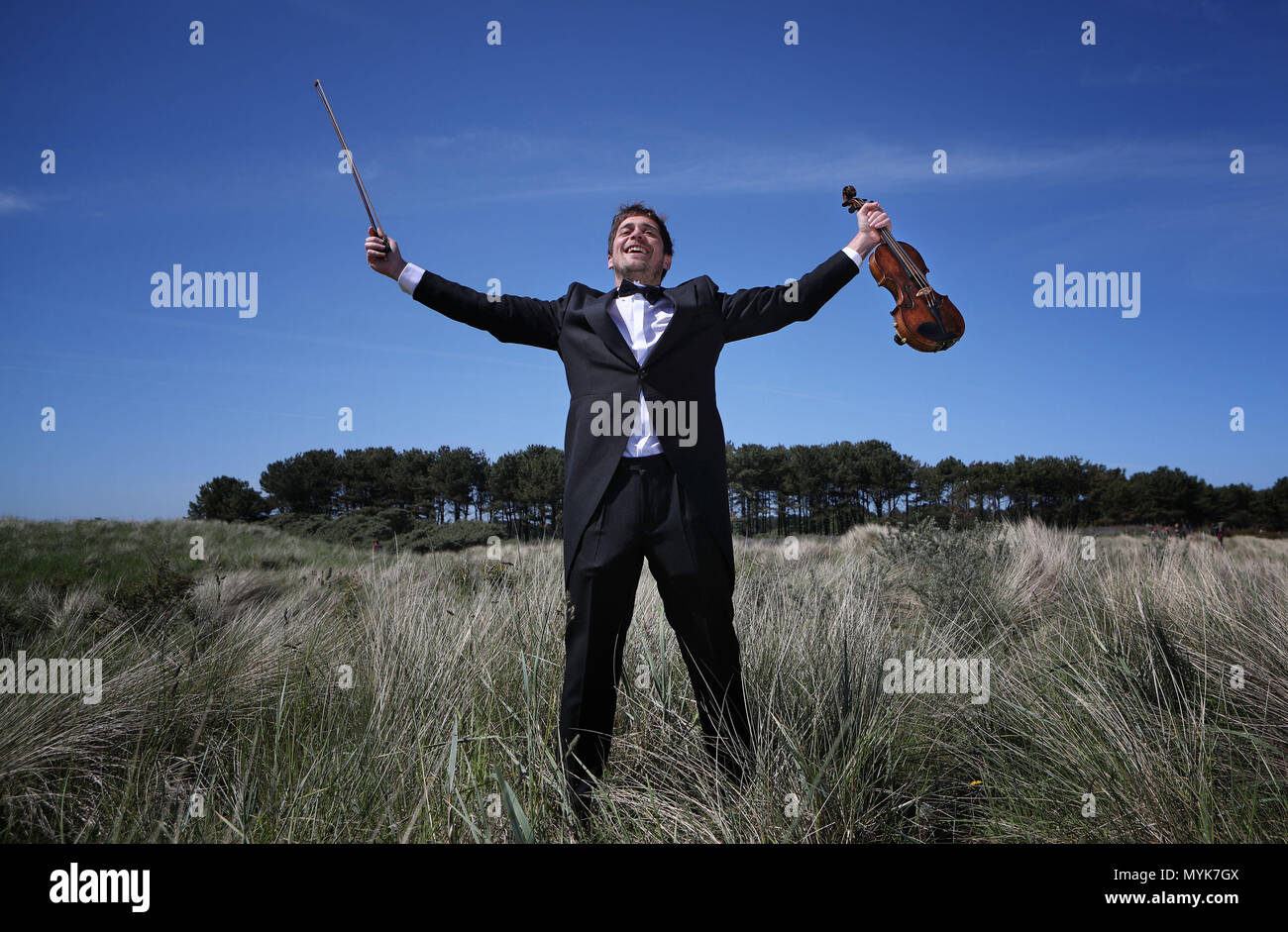 Musician Thoren Ferguson with the Il Mare Violin, which is made from driftwood at Yellowcraigs, East Lothian. Stock Photo