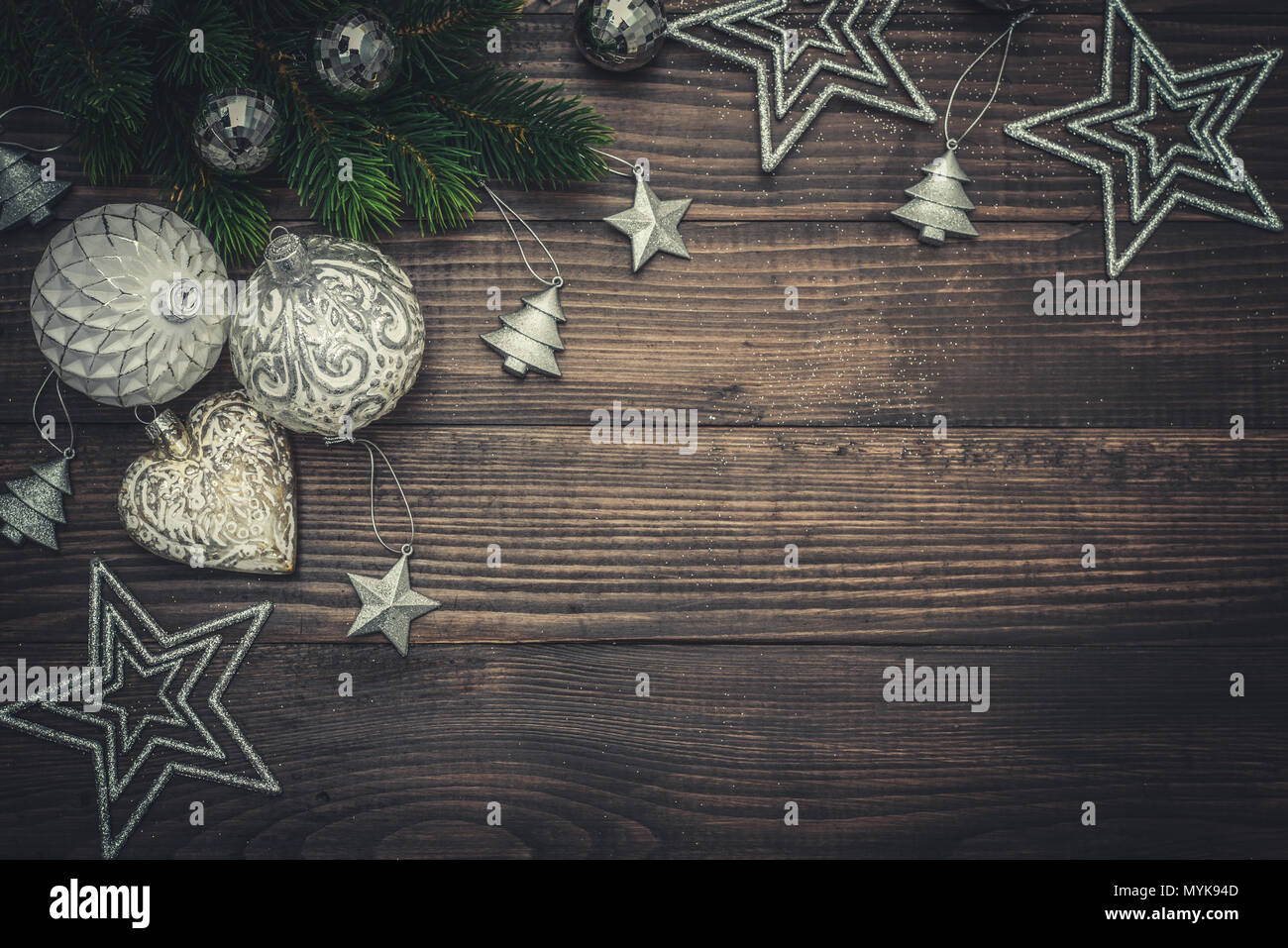 Christmas decorations with stars, fir tree twig  and candles on wooden background, top view Stock Photo