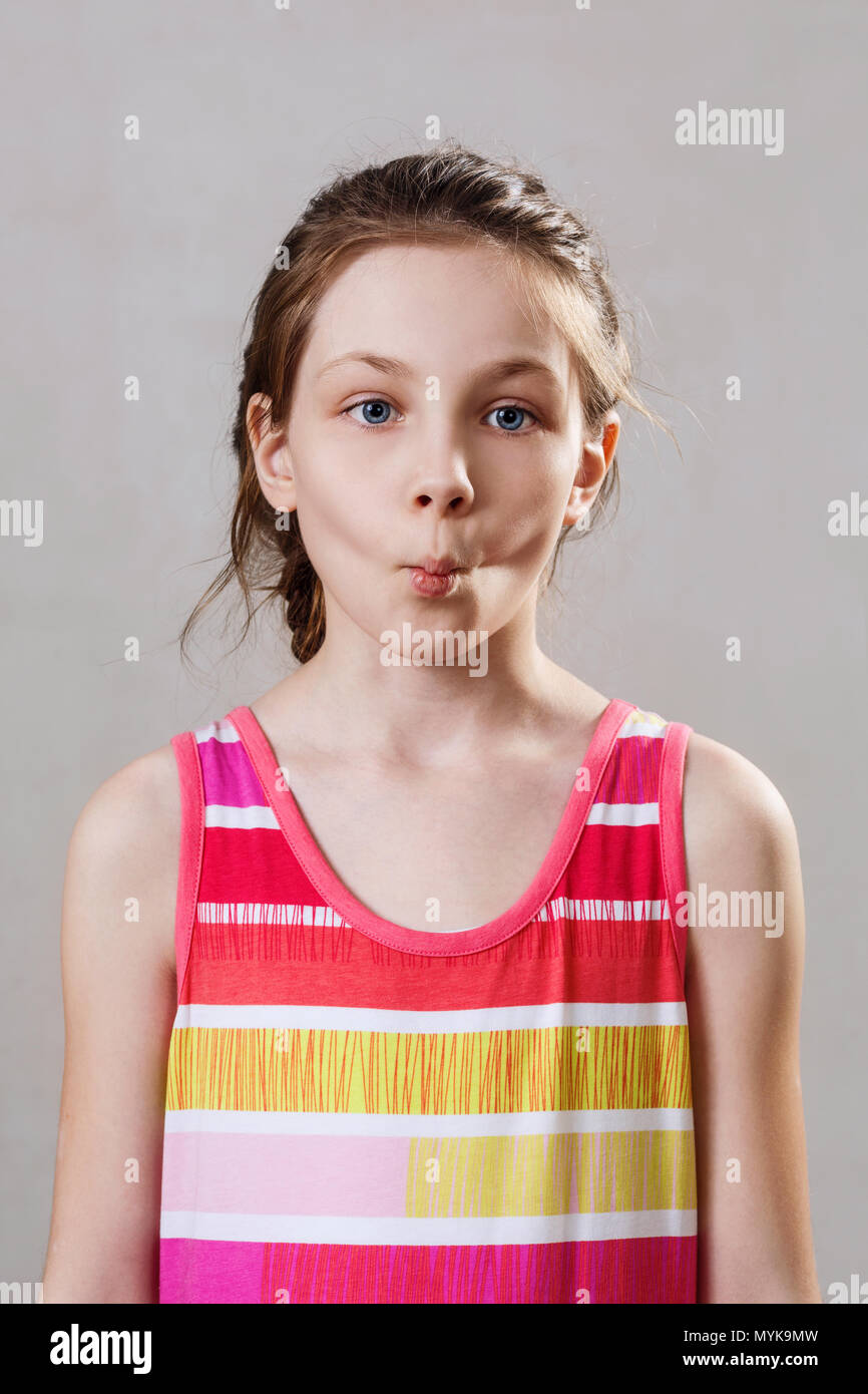 Portrait of little girl with funny fish expression. Stock Photo