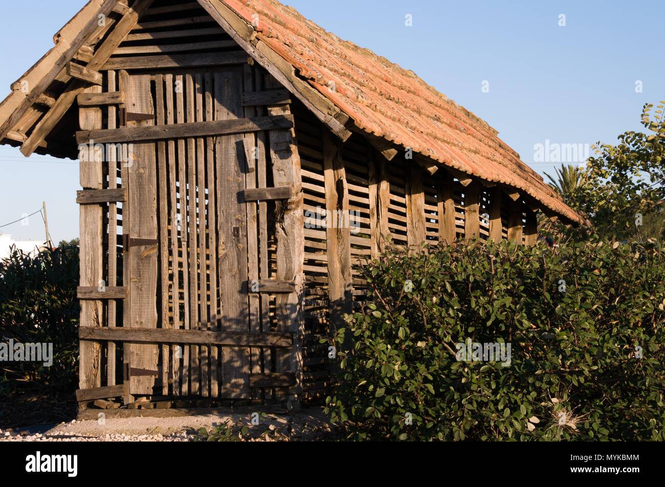 Field shed to guard tools of agriculture with vegetation Stock Photo