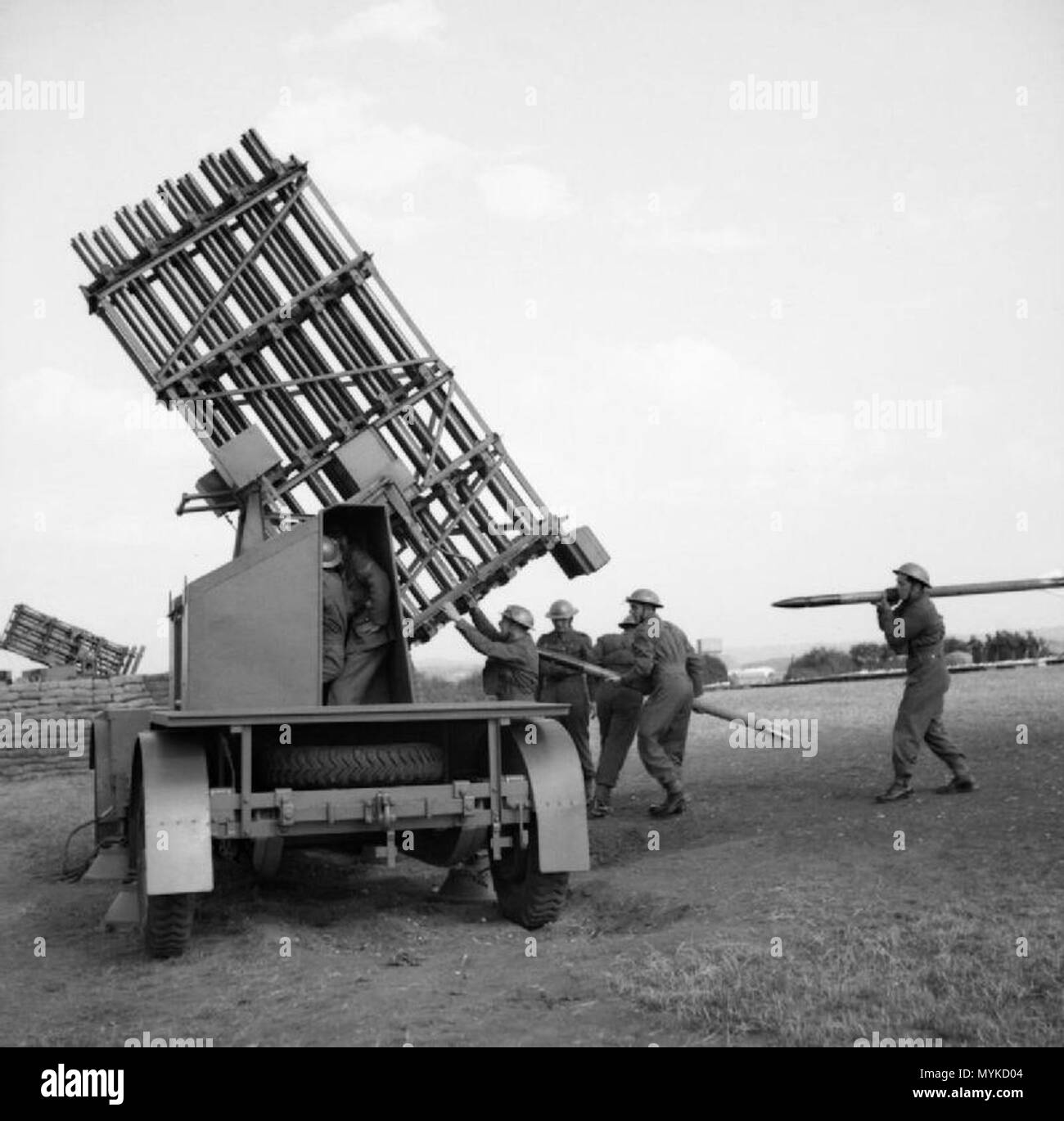 . IWM caption : Royal Artillerymen at a 'Z' Battery load 4-inch anti-aircraft rockets into a mobile launcher. Comment : These are actually 3-inch rockets. 18 June 1941. War Office official photographer 367 Mobile Z battery 1941 IWM H 10791 Stock Photo